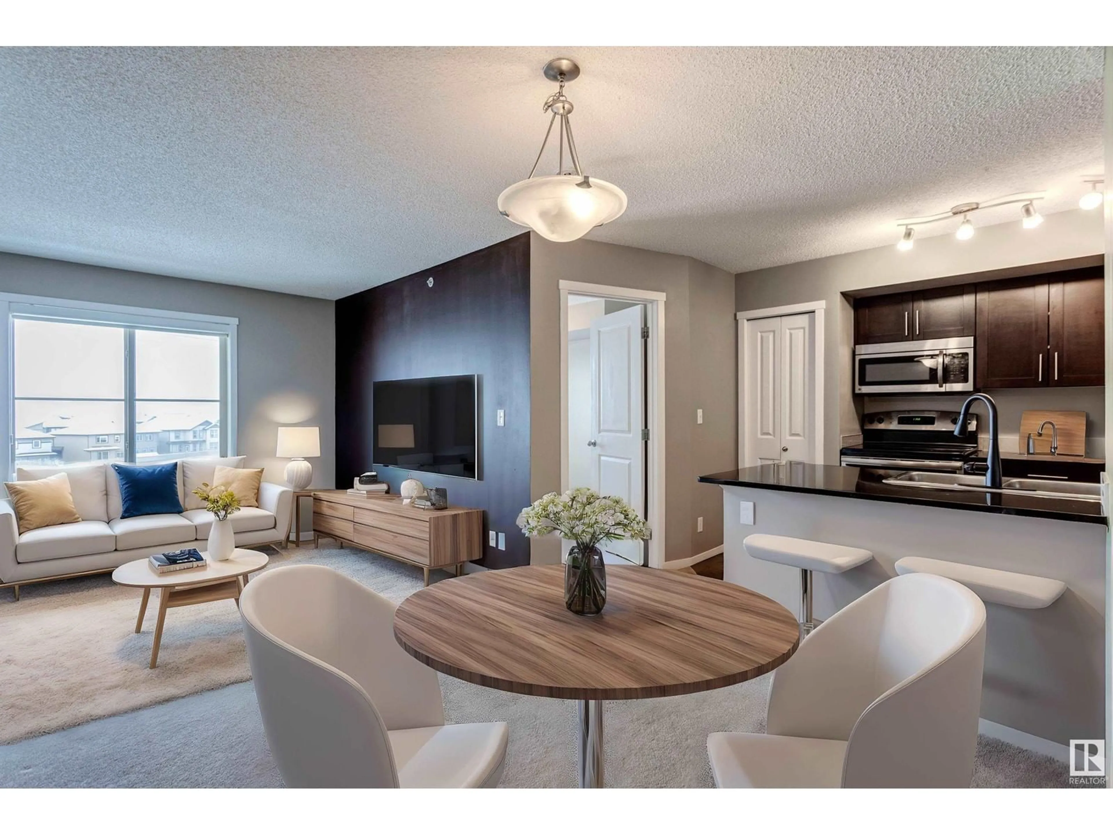 Open concept kitchen, wood/laminate floor for #421 5370 CHAPPELLE RD SW, Edmonton Alberta T6W3L5