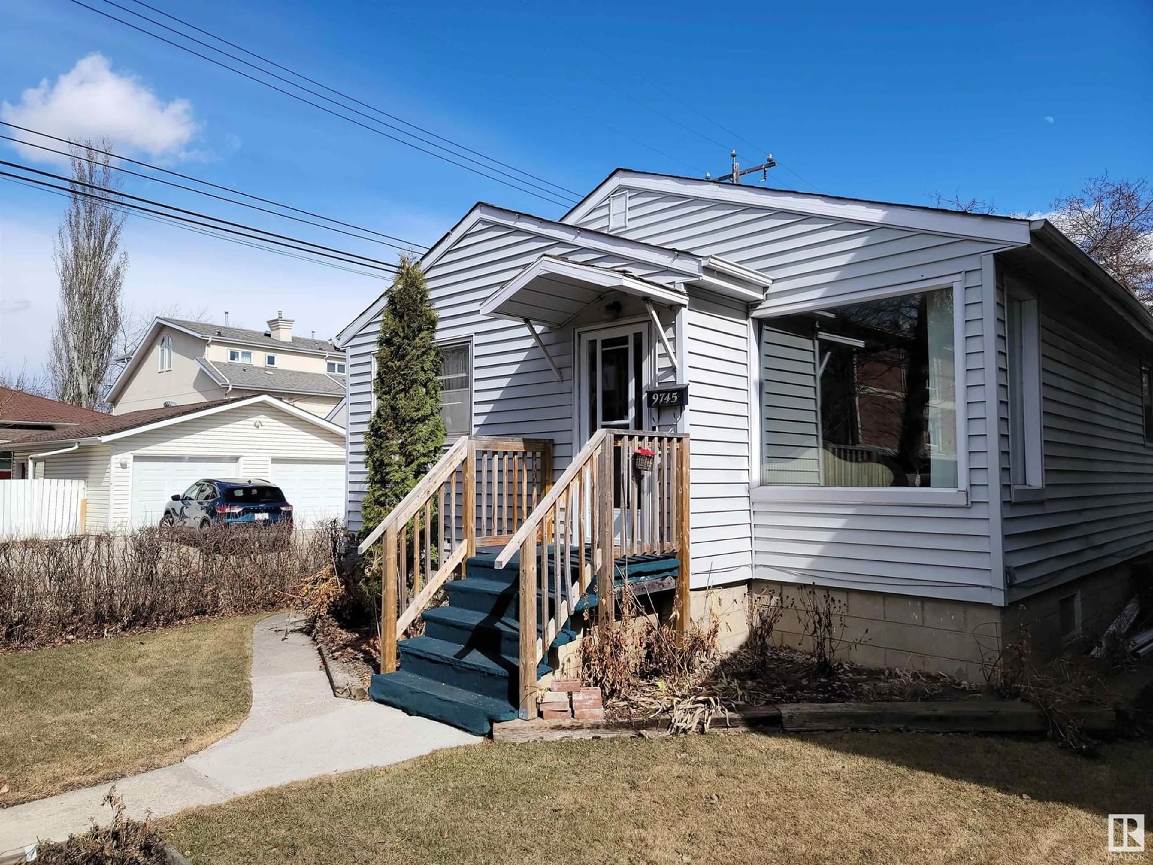 Home with vinyl exterior material, street for 9745 94 ST NW, Edmonton Alberta T6C3W1