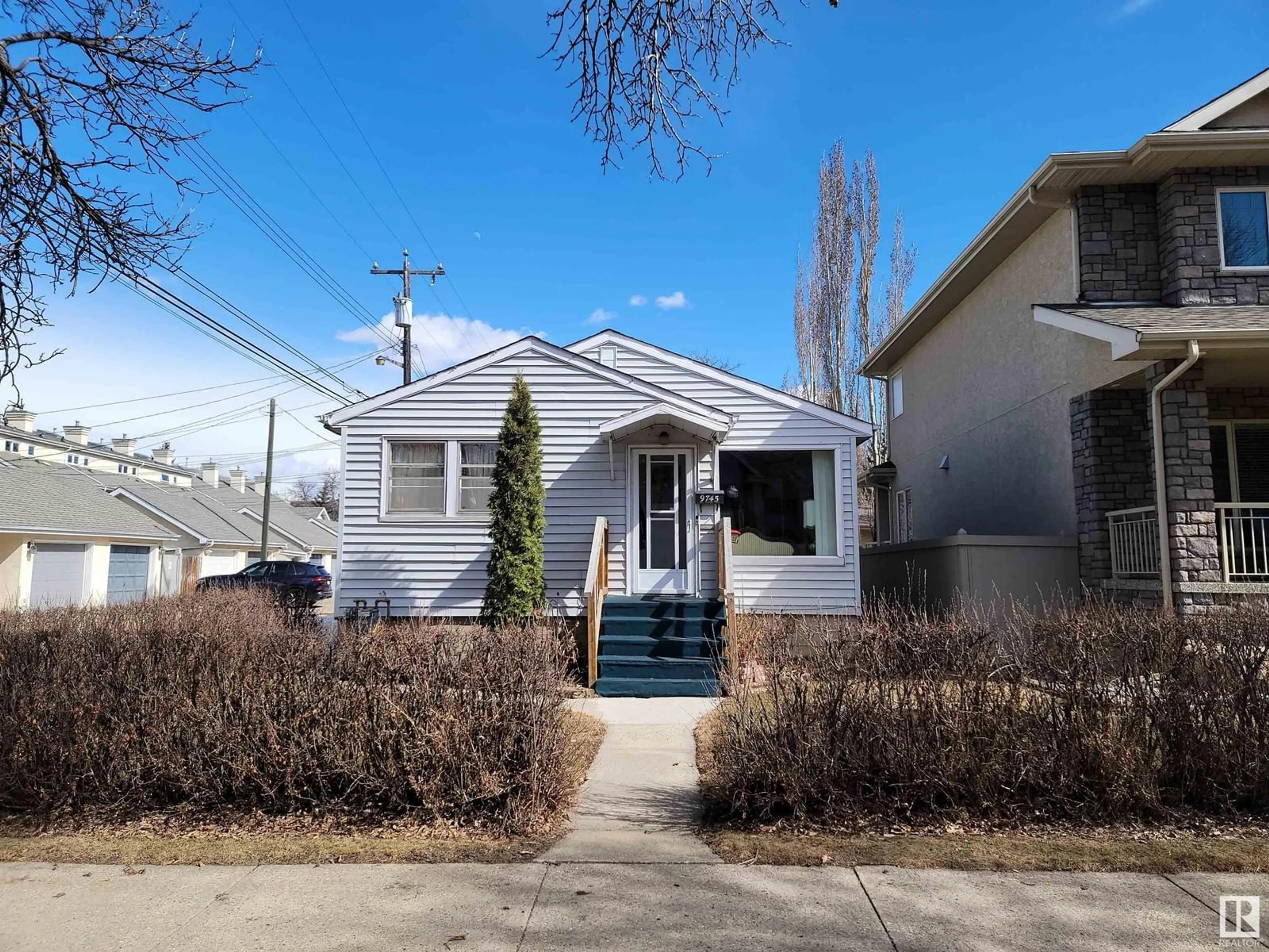 Home with vinyl exterior material, street for 9745 94 ST NW, Edmonton Alberta T6C3W1