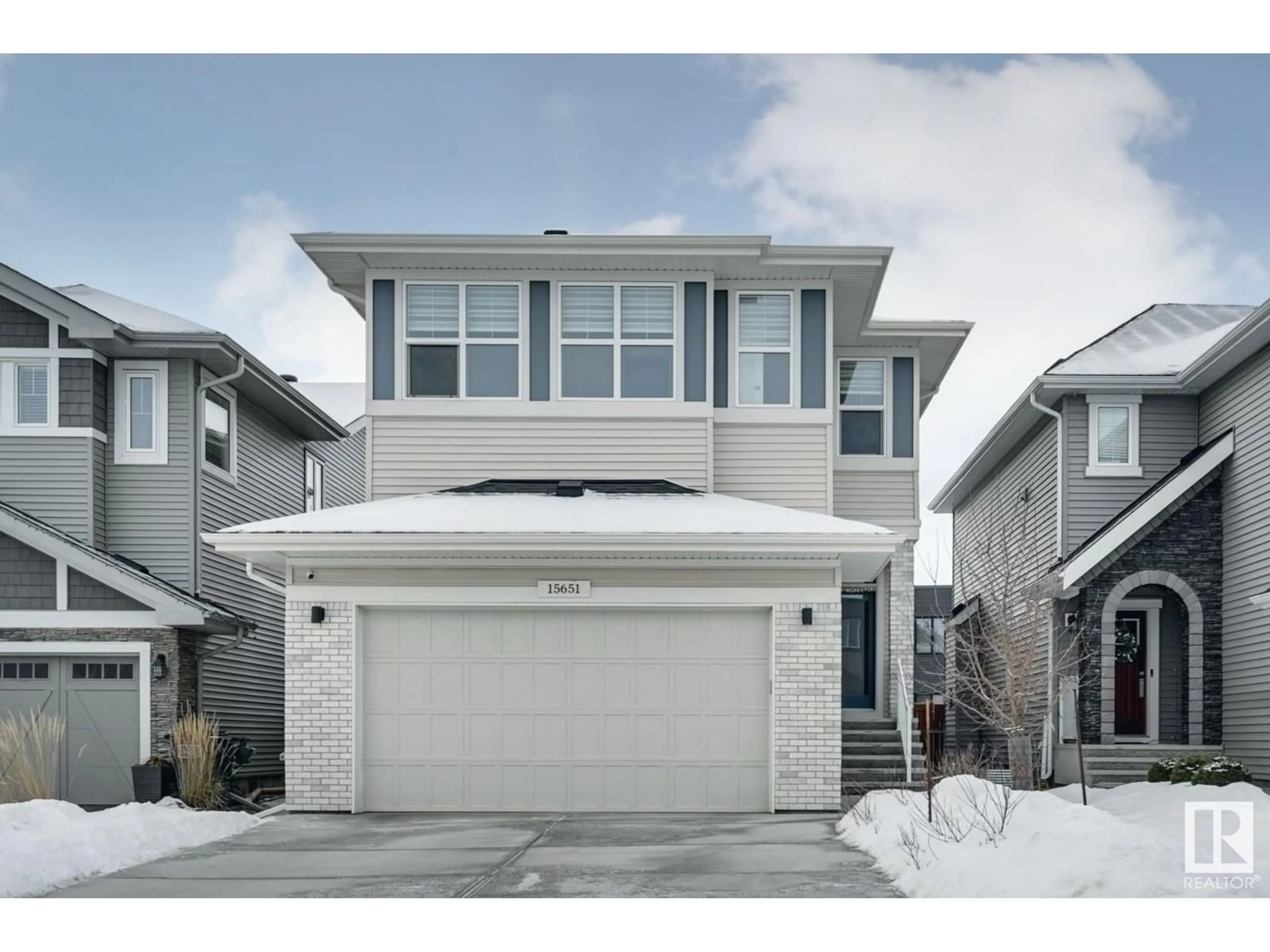 Home with vinyl exterior material, street for 15651 14 AV SW, Edmonton Alberta T6W4E4