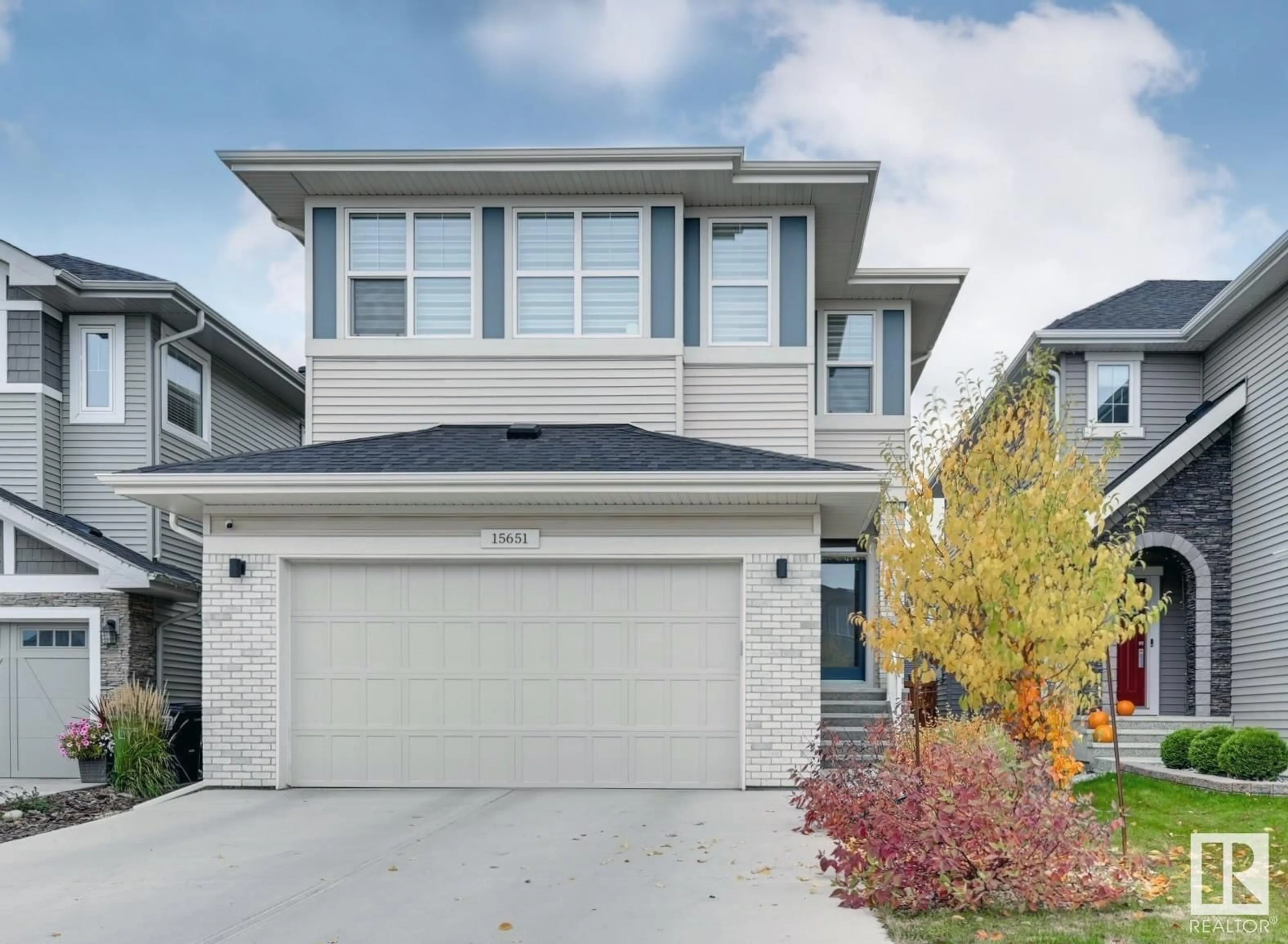 Home with vinyl exterior material, street for 15651 14 AV SW, Edmonton Alberta T6W4E4