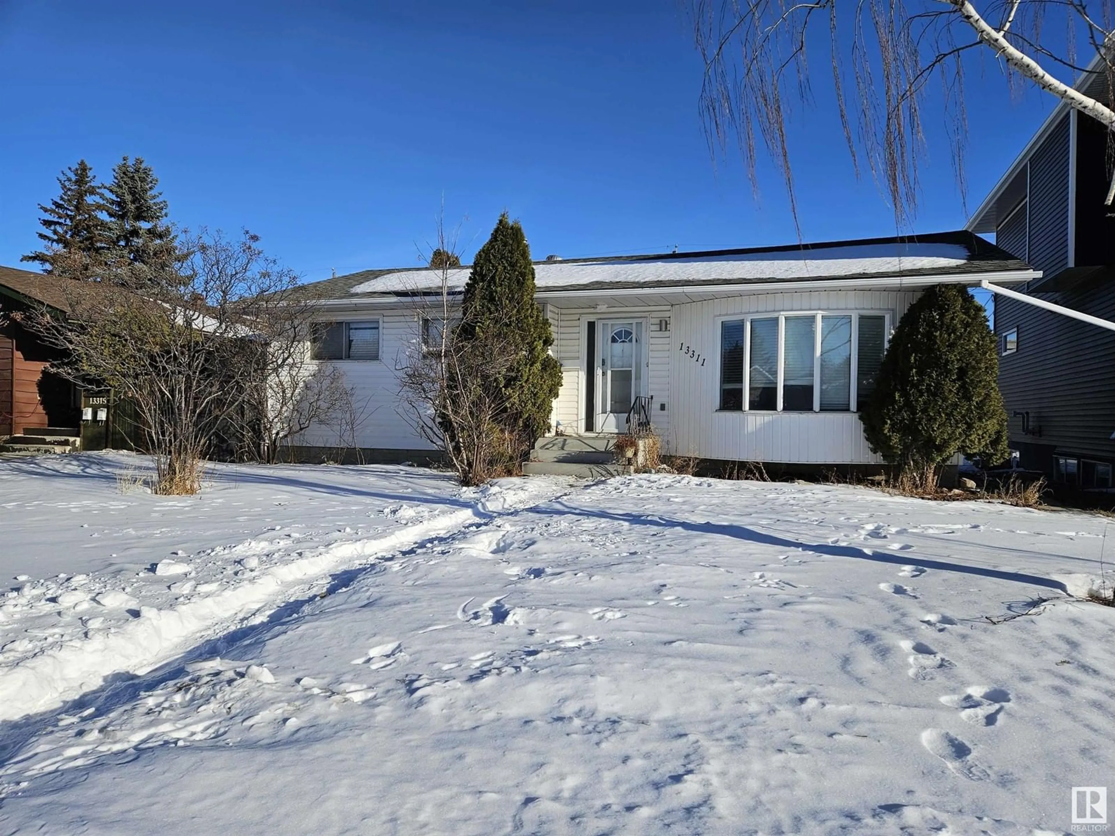 Home with vinyl exterior material, street for 13311 128 ST NW, Edmonton Alberta T5L1E7