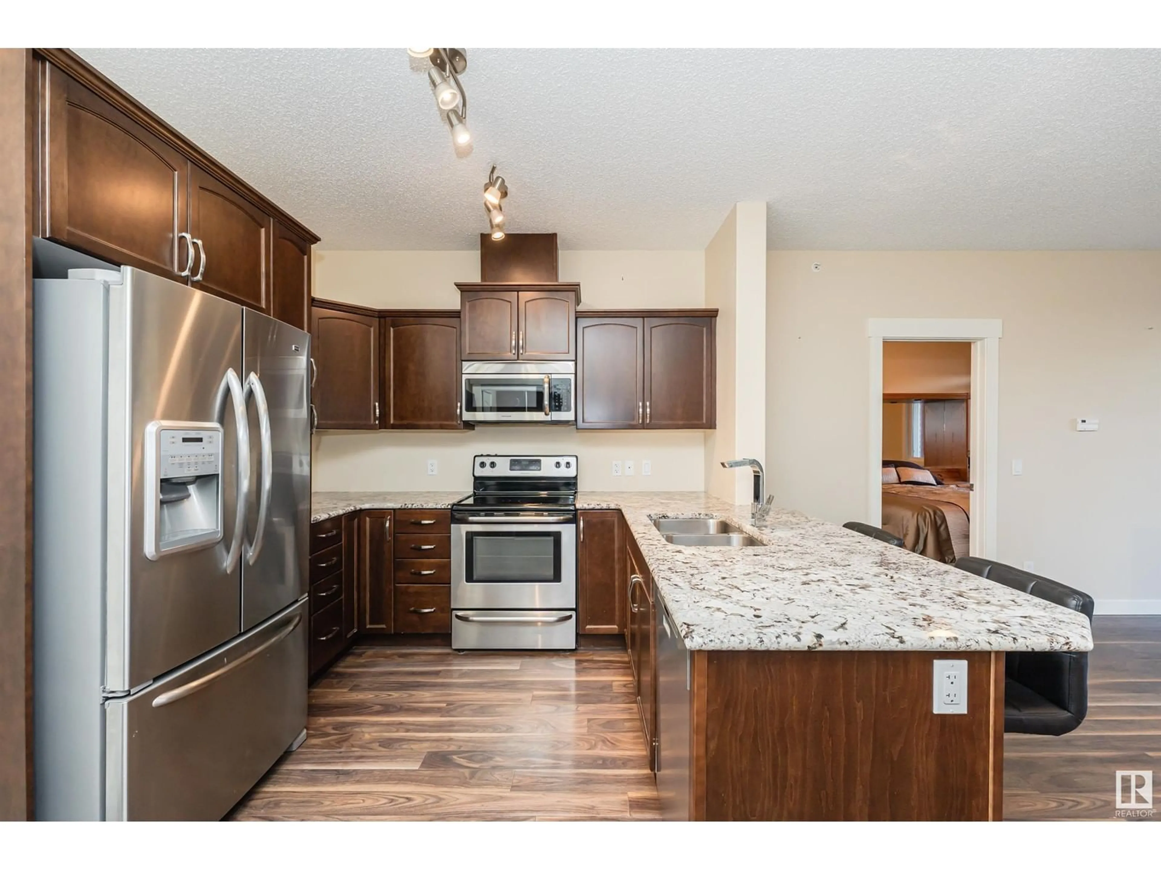 Open concept kitchen, wood/laminate floor for #414 - 511 QUEEN ST, Spruce Grove Alberta T7X0G4