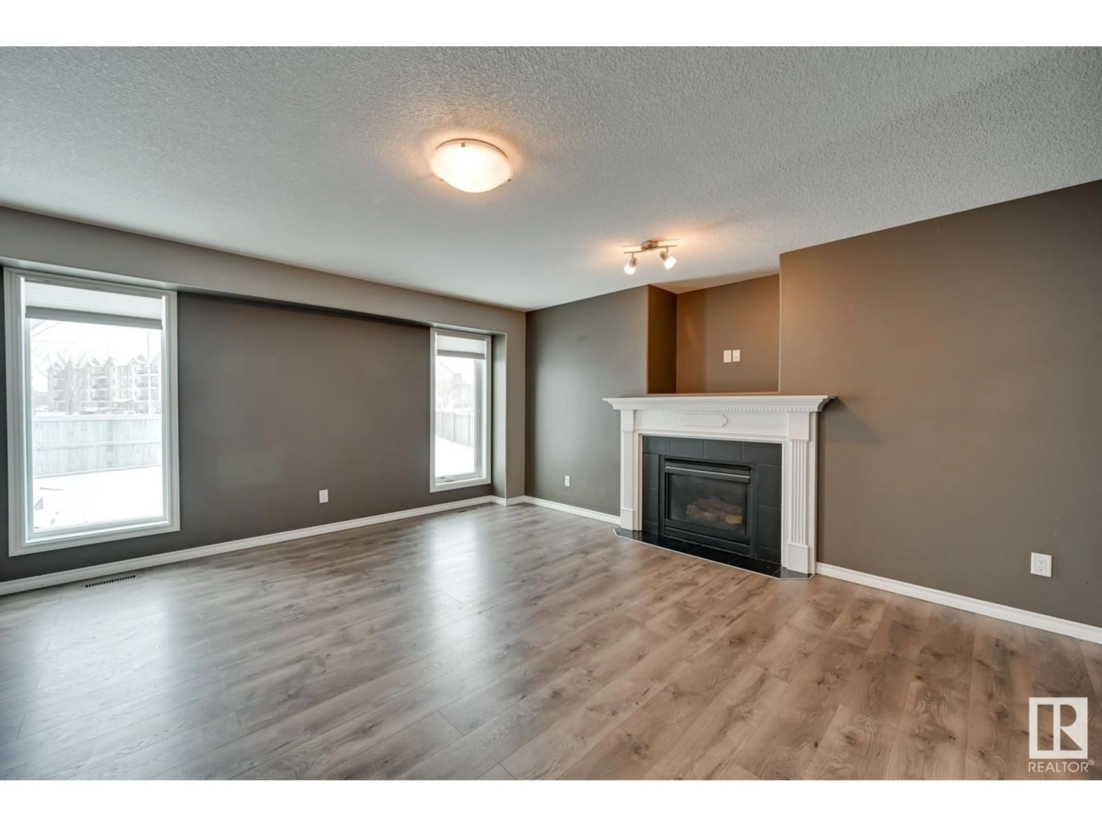 Living room with furniture, wood/laminate floor for 21 ROCKLEY PL, Fort Saskatchewan Alberta T8L0E7