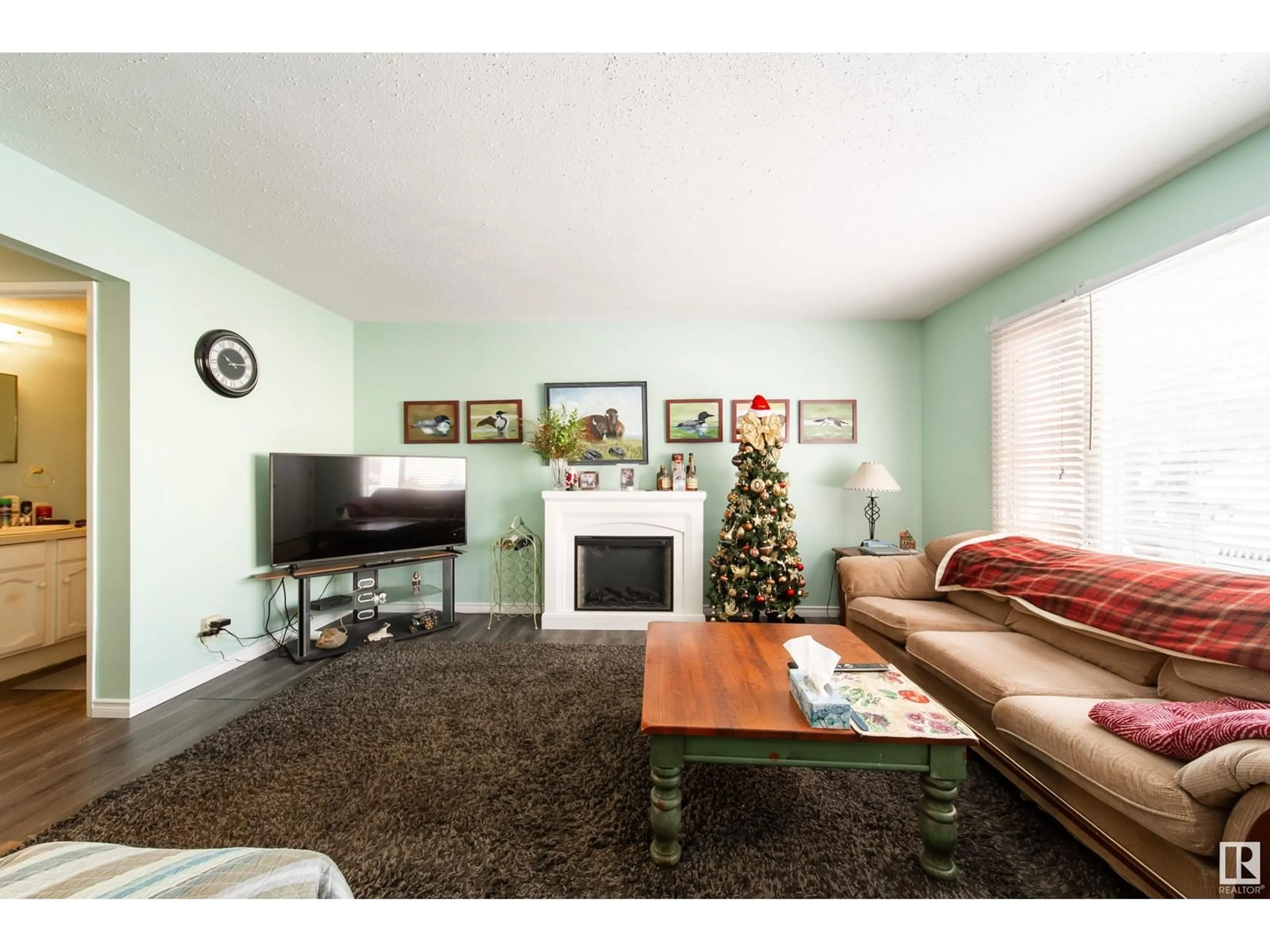 Living room with furniture, wood/laminate floor for 11313 22 AV NW, Edmonton Alberta T6J4V8