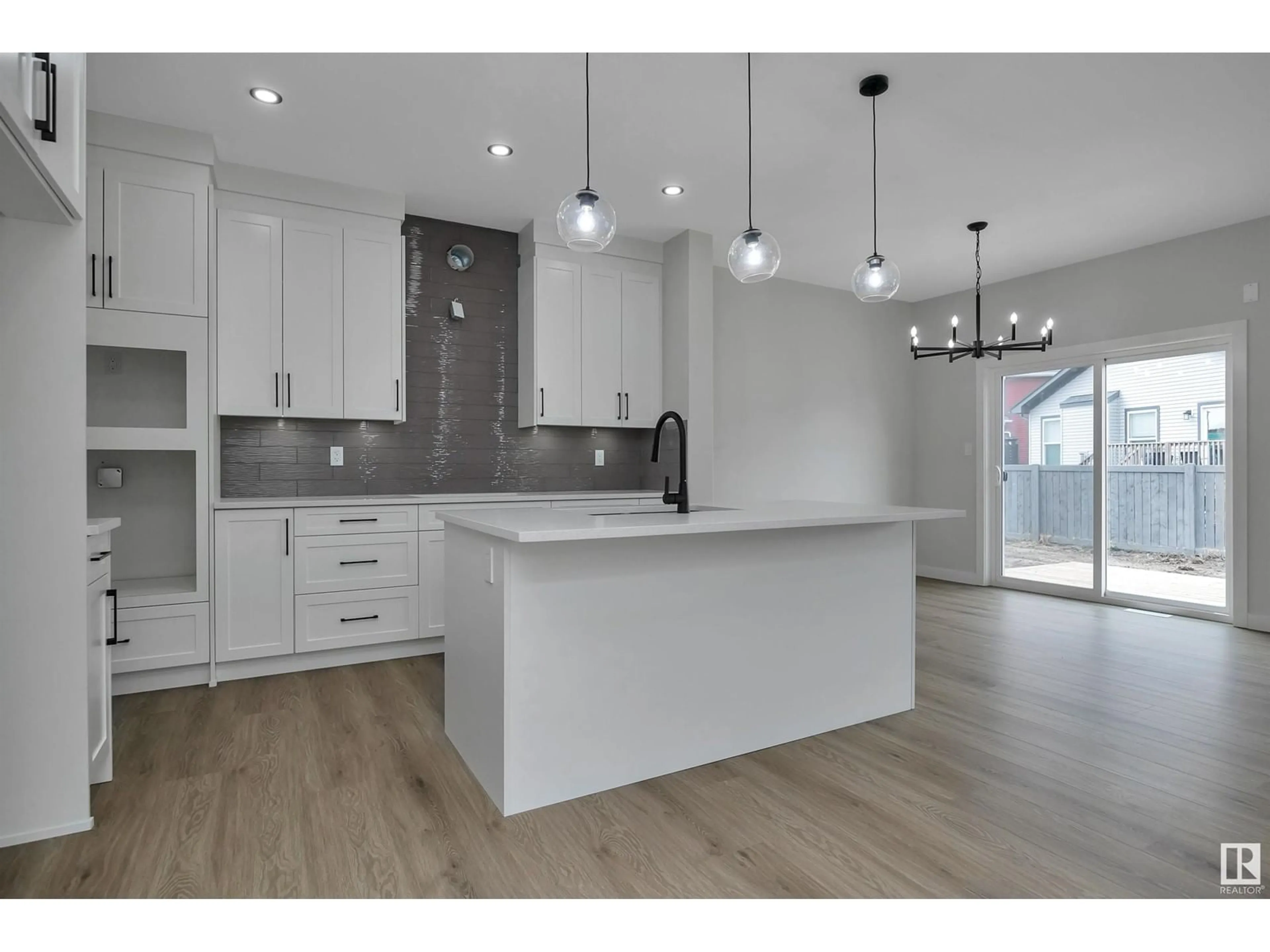 Open concept kitchen, wood/laminate floor for 204 Kettyl Court, Leduc Alberta T9E1B6