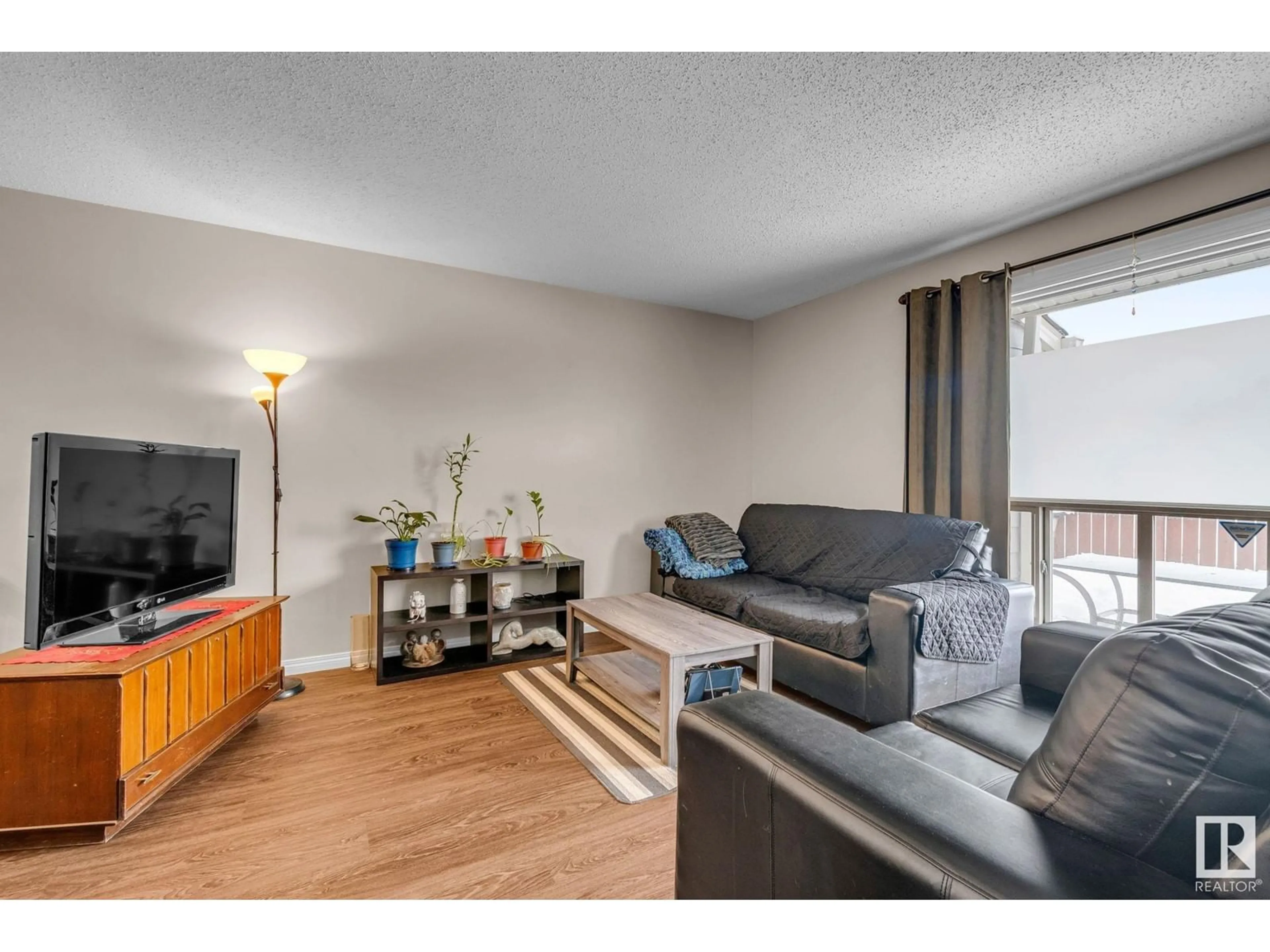 Living room with furniture, wood/laminate floor for 2320 151 AV NW NW, Edmonton Alberta T5Y2L1