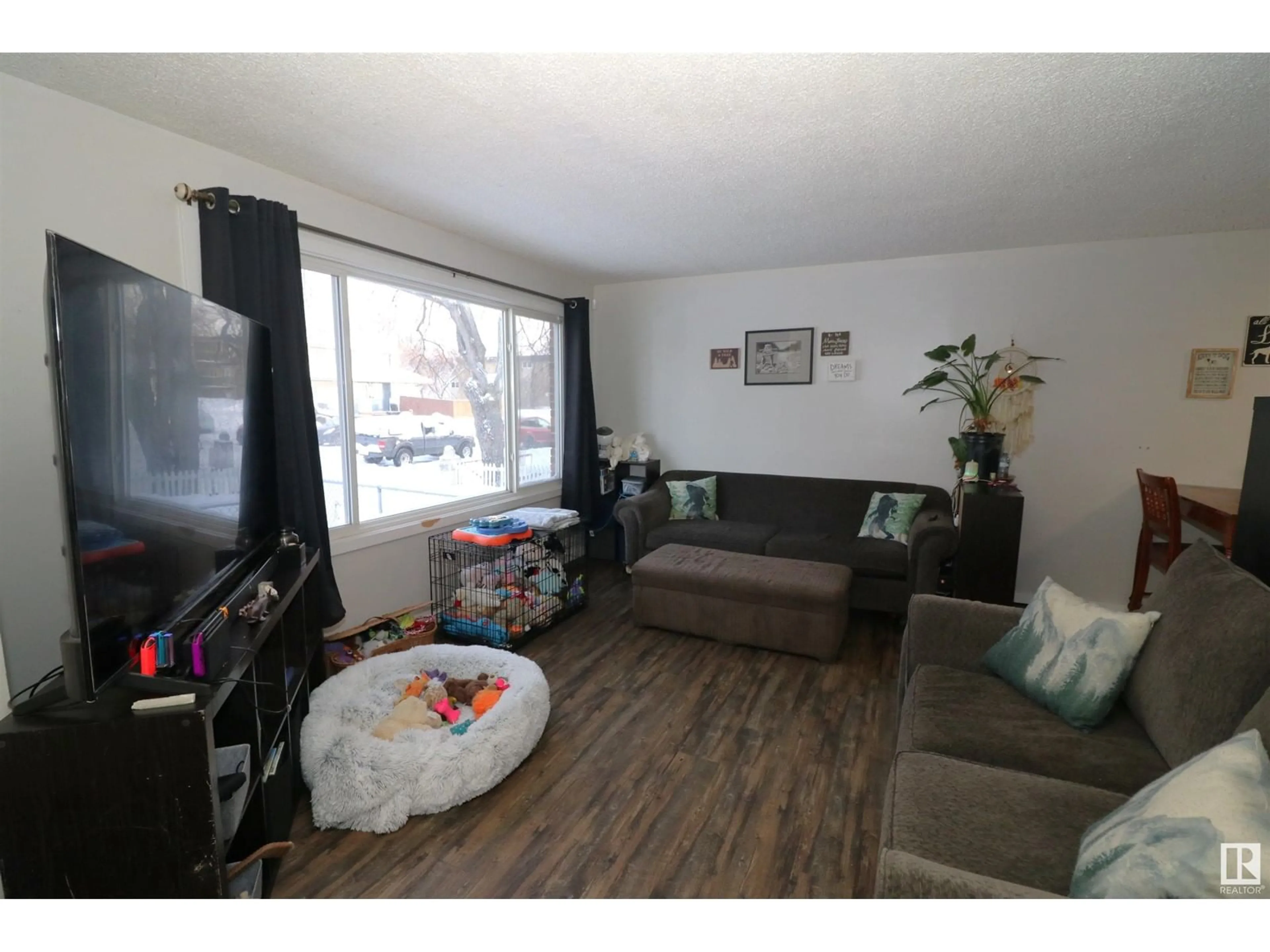 Living room with furniture, wood/laminate floor for 10214 155 ST NW, Edmonton Alberta T5P2L7