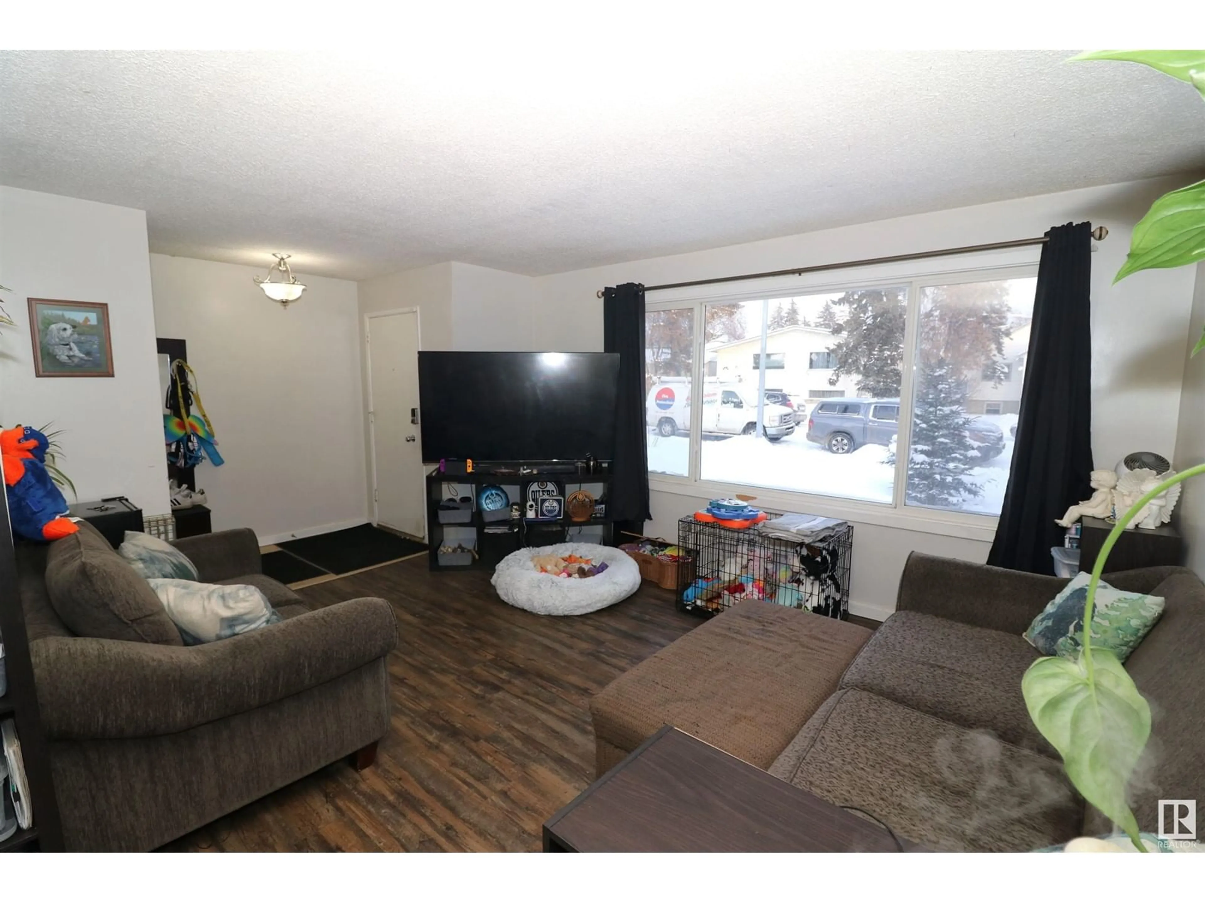 Living room with furniture, wood/laminate floor for 10214 155 ST NW, Edmonton Alberta T5P2L7