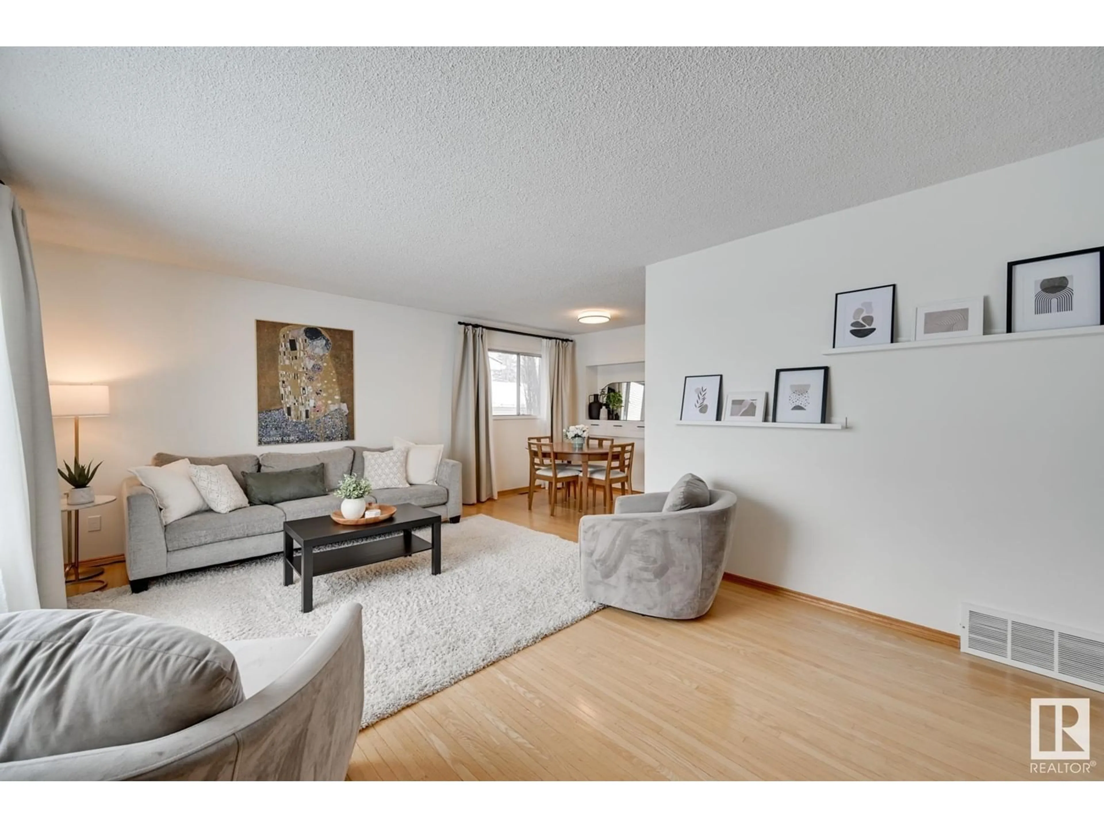 Living room with furniture, wood/laminate floor for 6004 92 AV NW, Edmonton Alberta T6B0S4