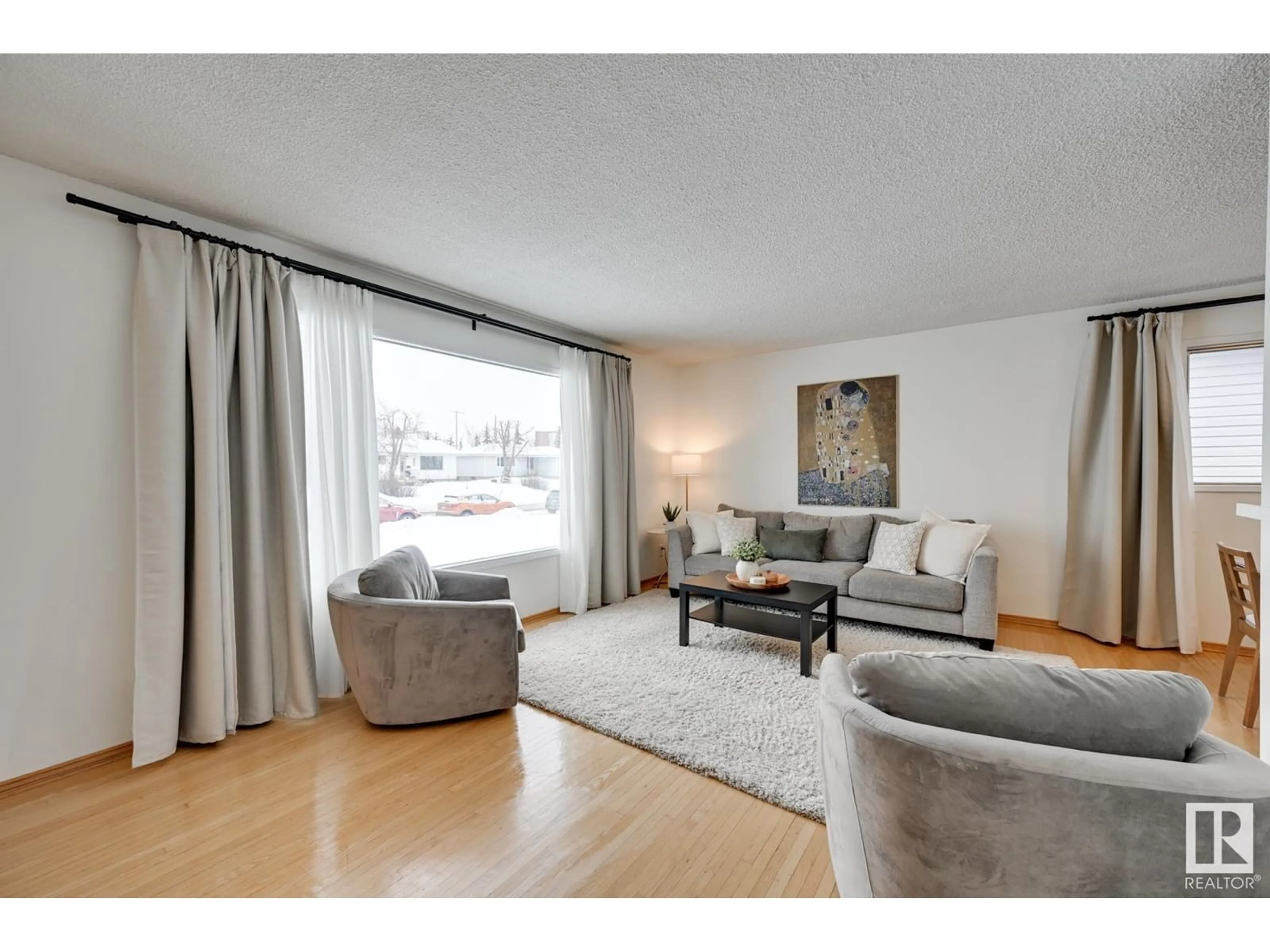 Living room with furniture, wood/laminate floor for 6004 92 AV NW, Edmonton Alberta T6B0S4