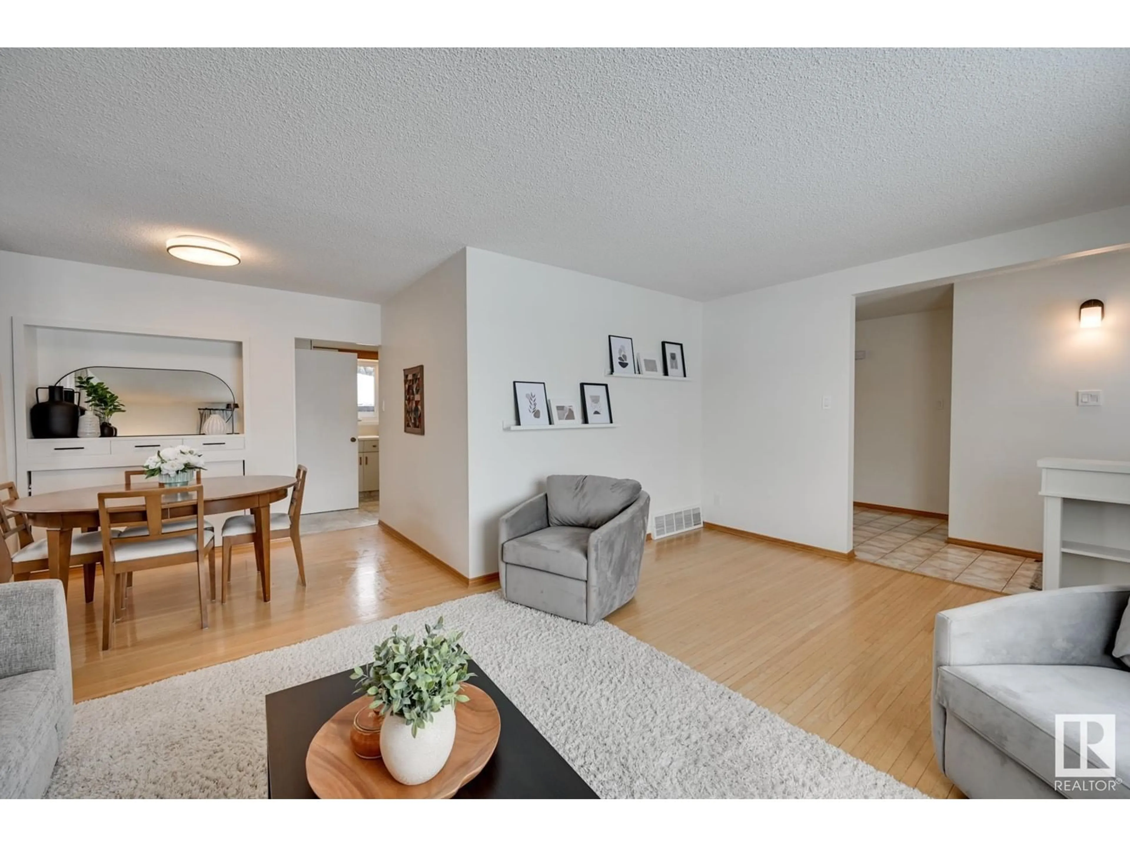 Living room with furniture, wood/laminate floor for 6004 92 AV NW, Edmonton Alberta T6B0S4