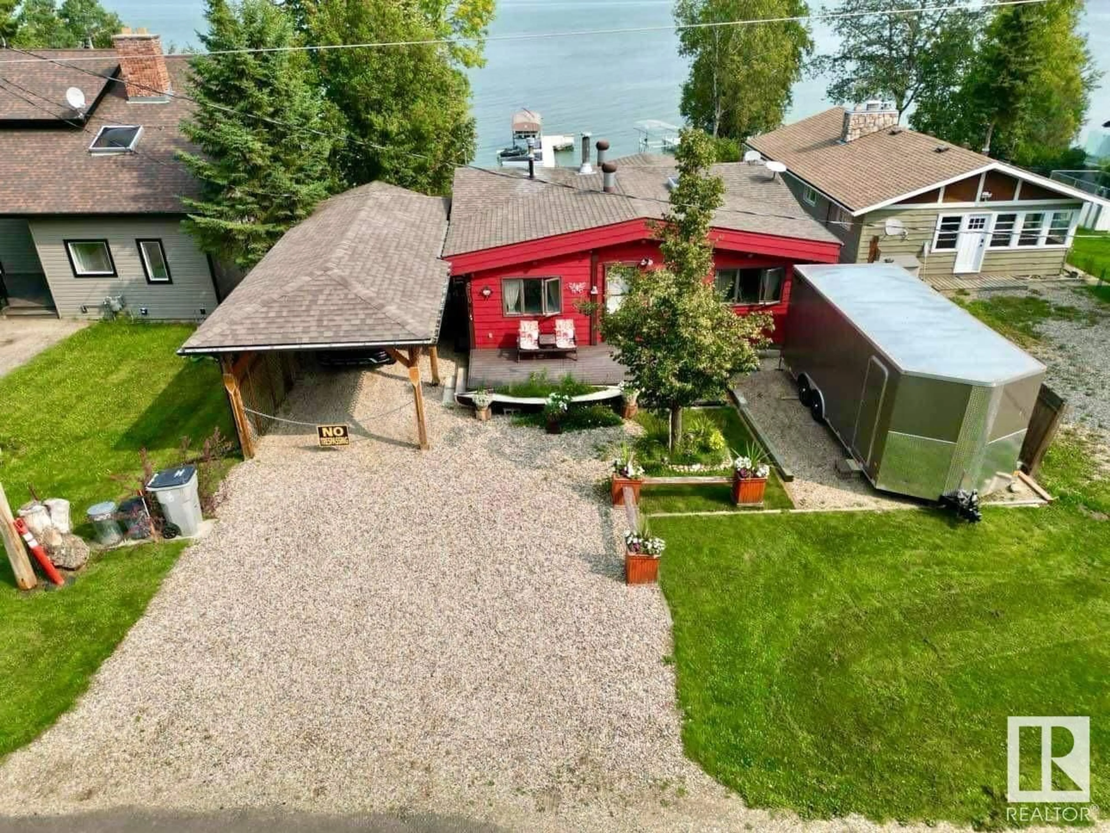 A pic from outside/outdoor area/front of a property/back of a property/a pic from drone, water/lake/river/ocean view for 510 5 ST, Rural Wetaskiwin County Alberta T0C2V0