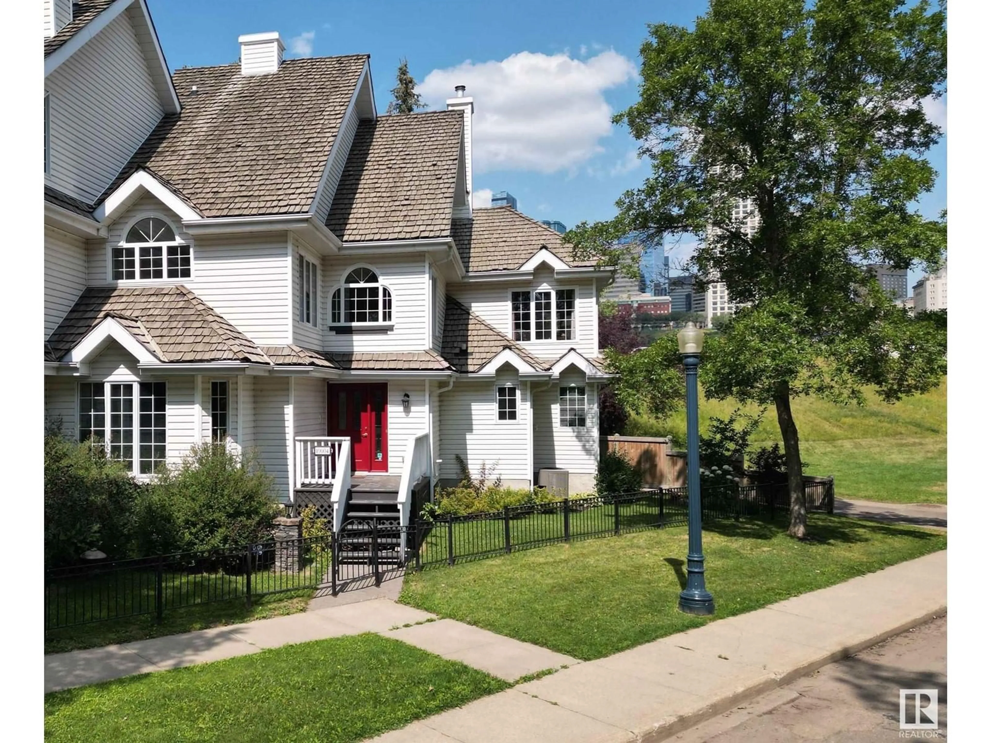 Home with vinyl exterior material, street for 10004 97 AV NW, Edmonton Alberta T5K0B1