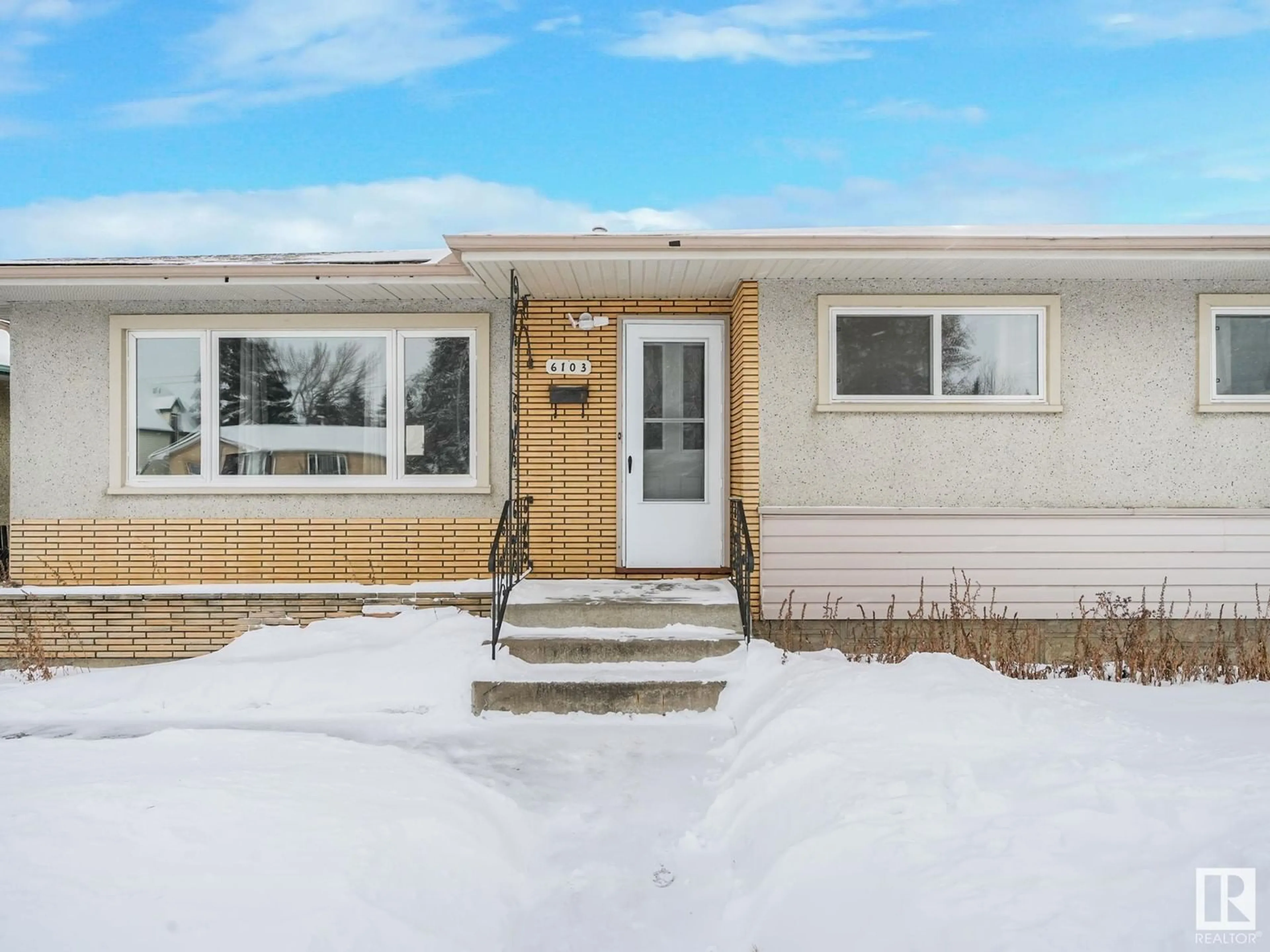 Home with vinyl exterior material, street for 6103 132 AV NW, Edmonton Alberta T5A0J8