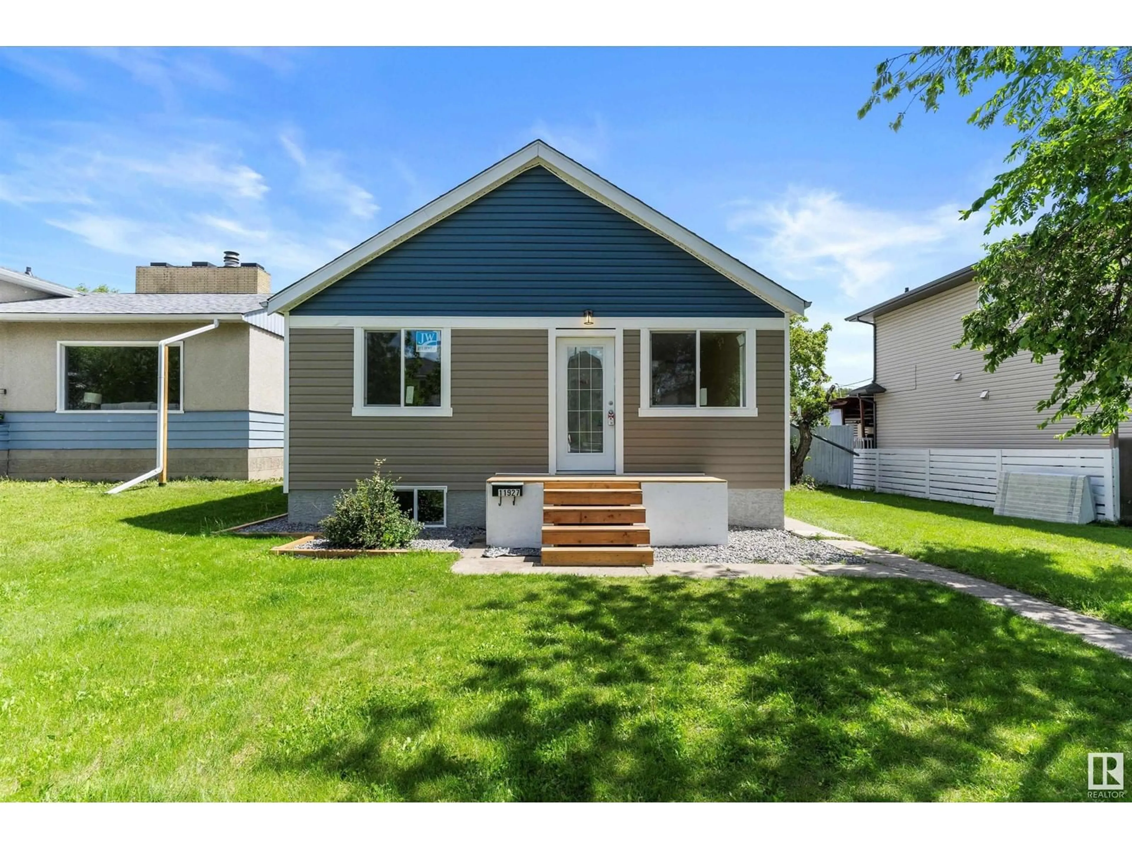 Home with vinyl exterior material, street for 11927 80 ST NW, Edmonton Alberta T5B2N8