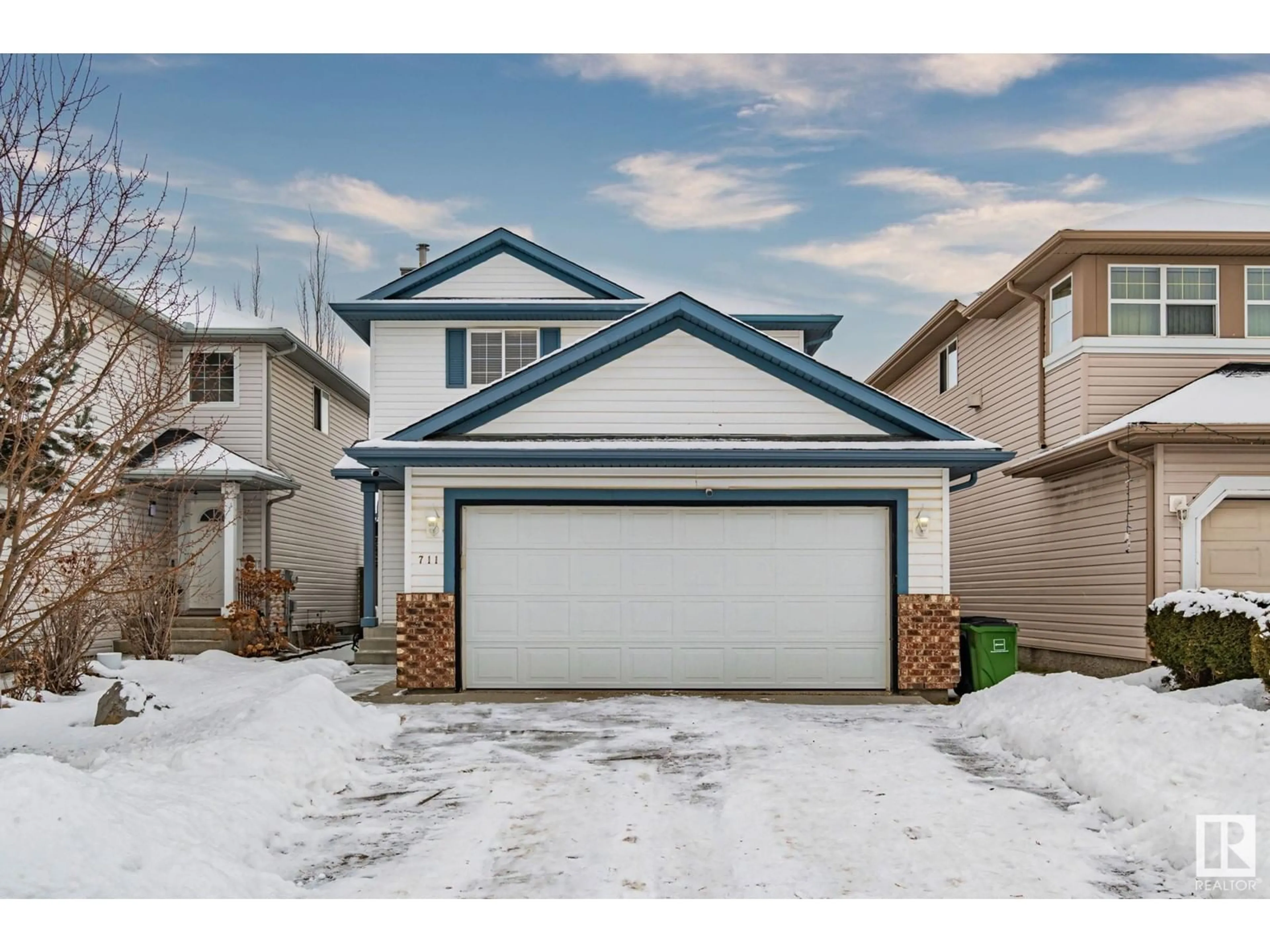 Home with vinyl exterior material, street for 711 89 ST SW SW, Edmonton Alberta T6X1B9