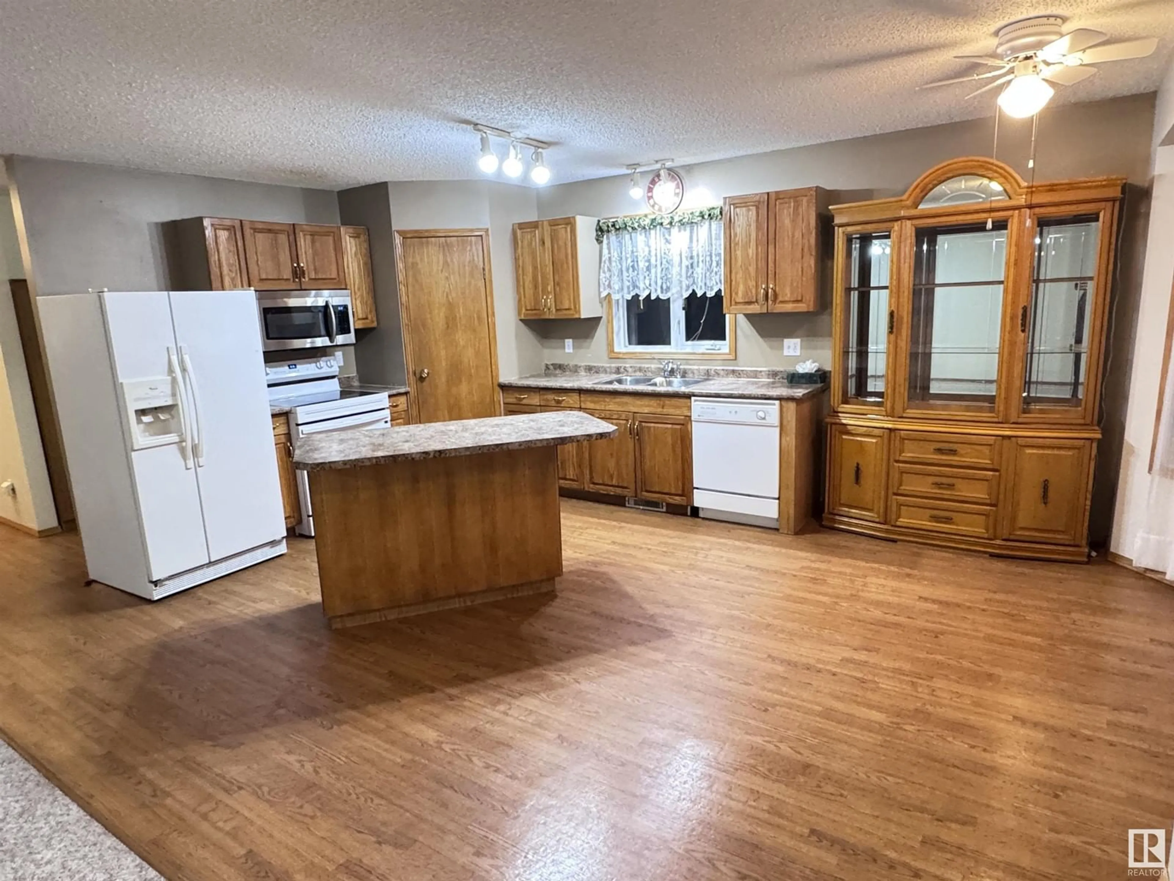 Open concept kitchen, wood/laminate floor for 10240 104 ST, Westlock Alberta T7P1V6