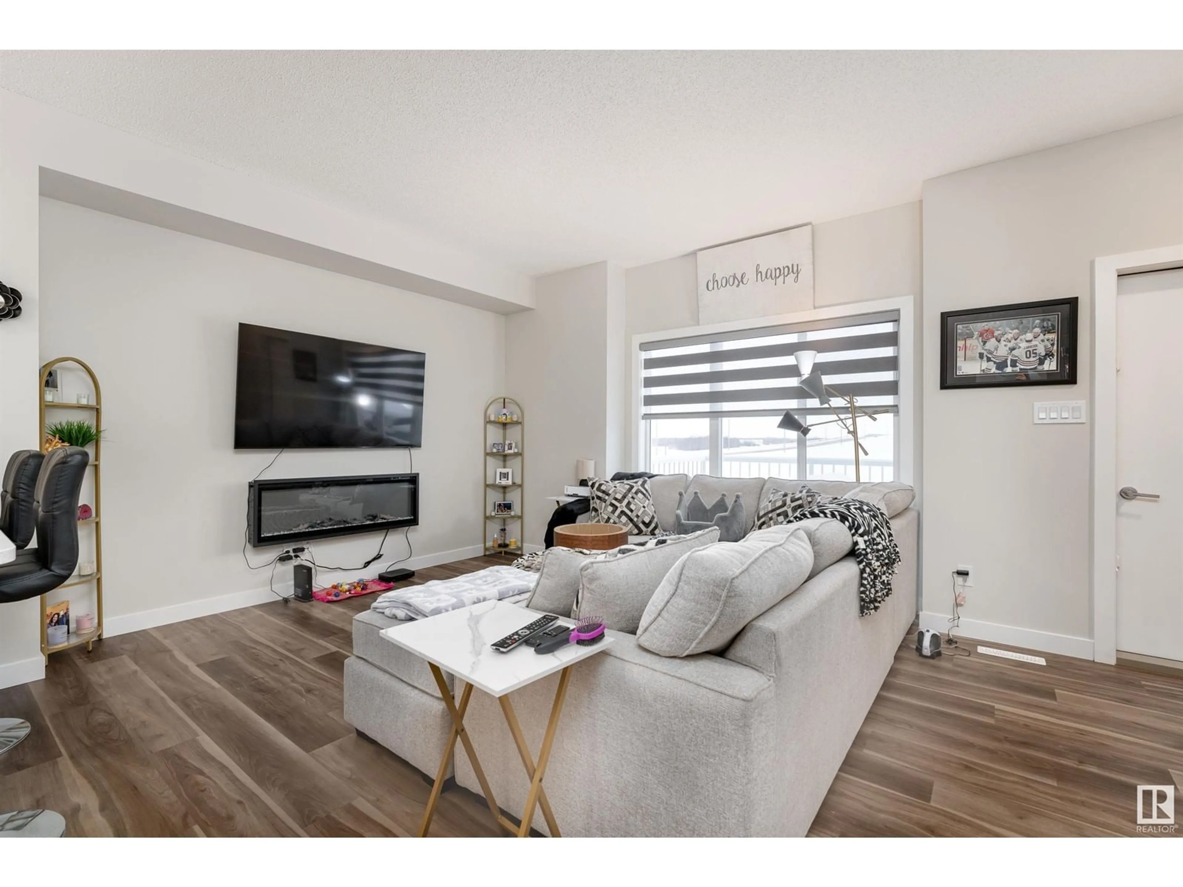 Living room with furniture, wood/laminate floor for #17 979 CRYSTALLINA NERA WY NW, Edmonton Alberta T5Z0S3