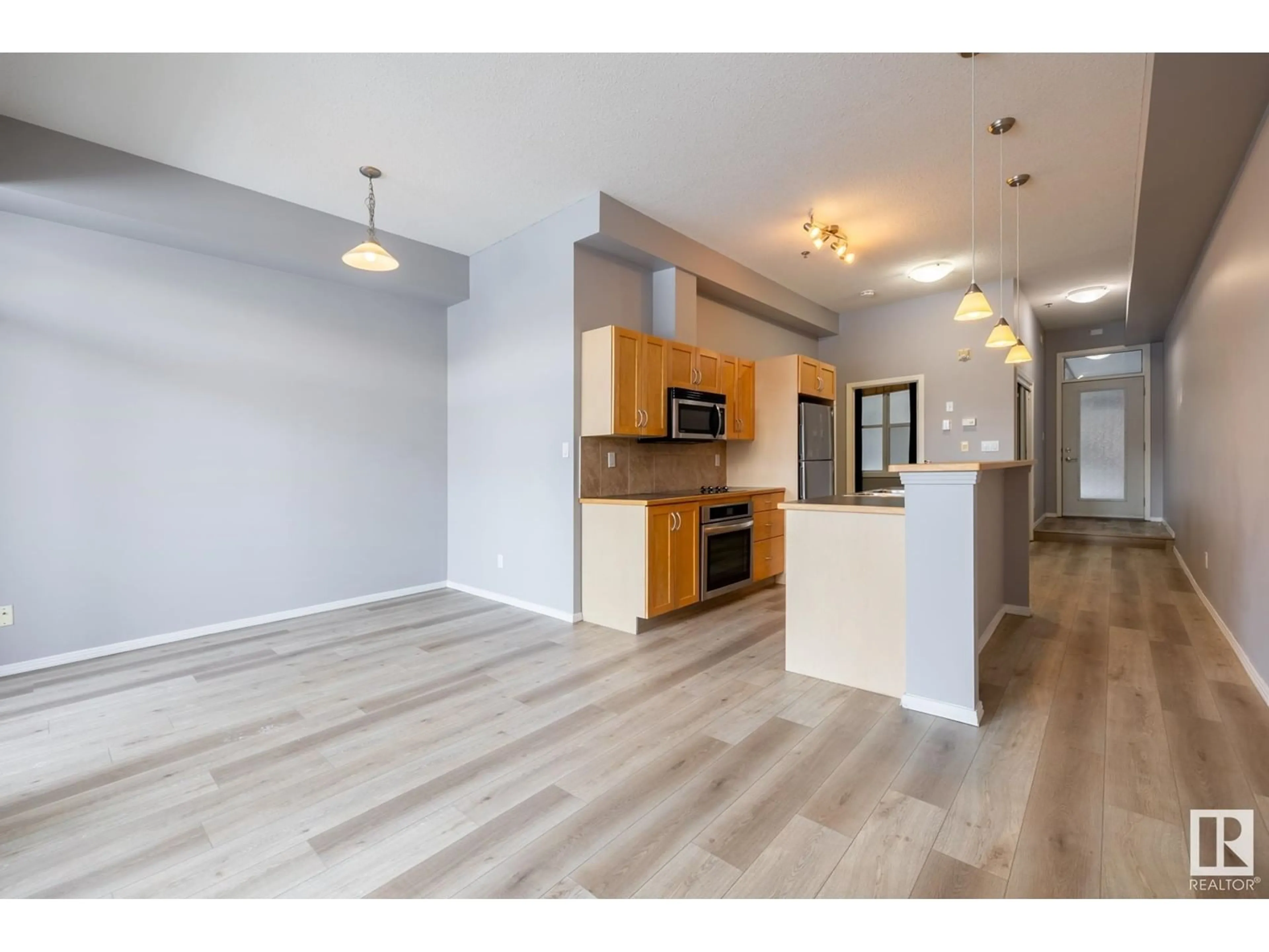 Open concept kitchen, wood/laminate floor for #210 10147 112 ST NW, Edmonton Alberta T5K1M1