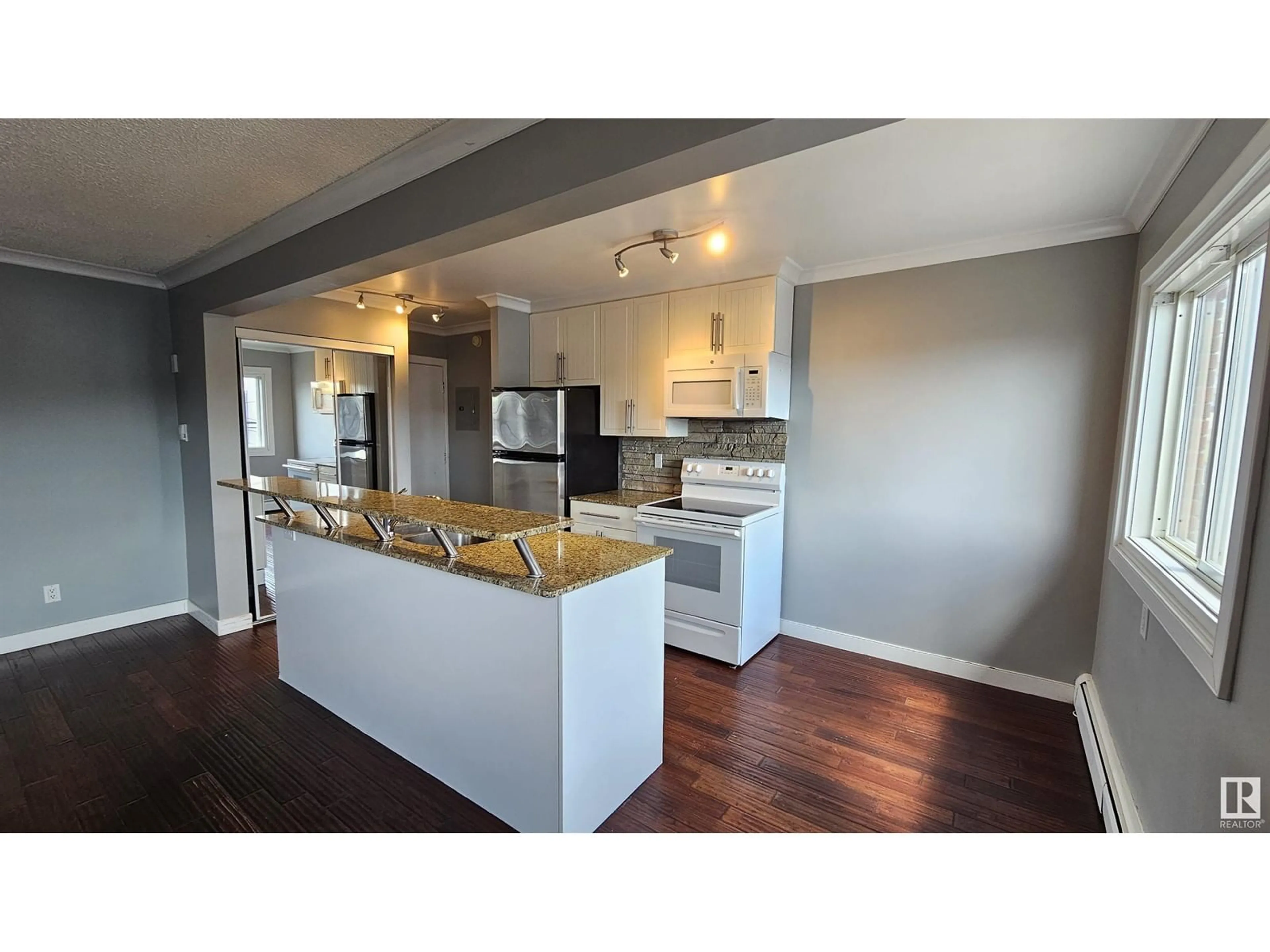 Open concept kitchen, wood/laminate floor for #34 10525 83 AV NW, Edmonton Alberta T6E2E1