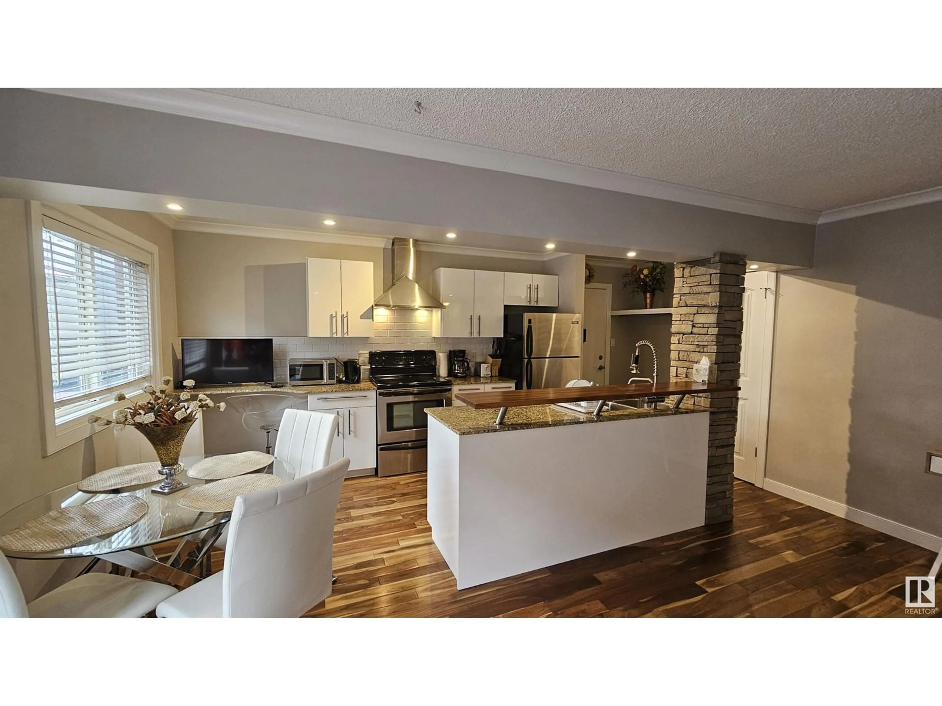 Open concept kitchen, wood/laminate floor for #23 10525 83 AV NW, Edmonton Alberta T6E2E1