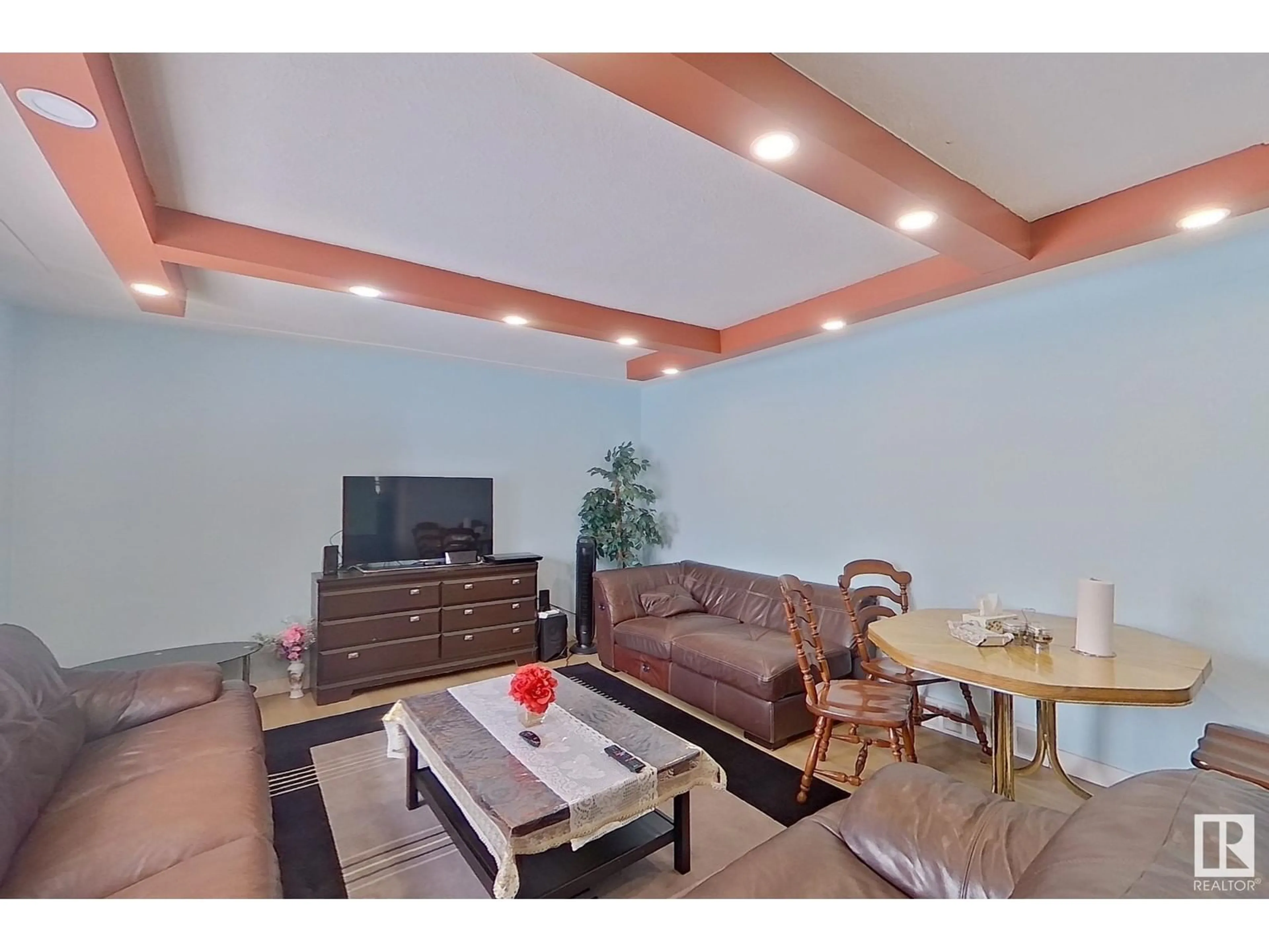 Living room with furniture, wood/laminate floor for 7928 82 AVE, Edmonton Alberta T6C0Y2