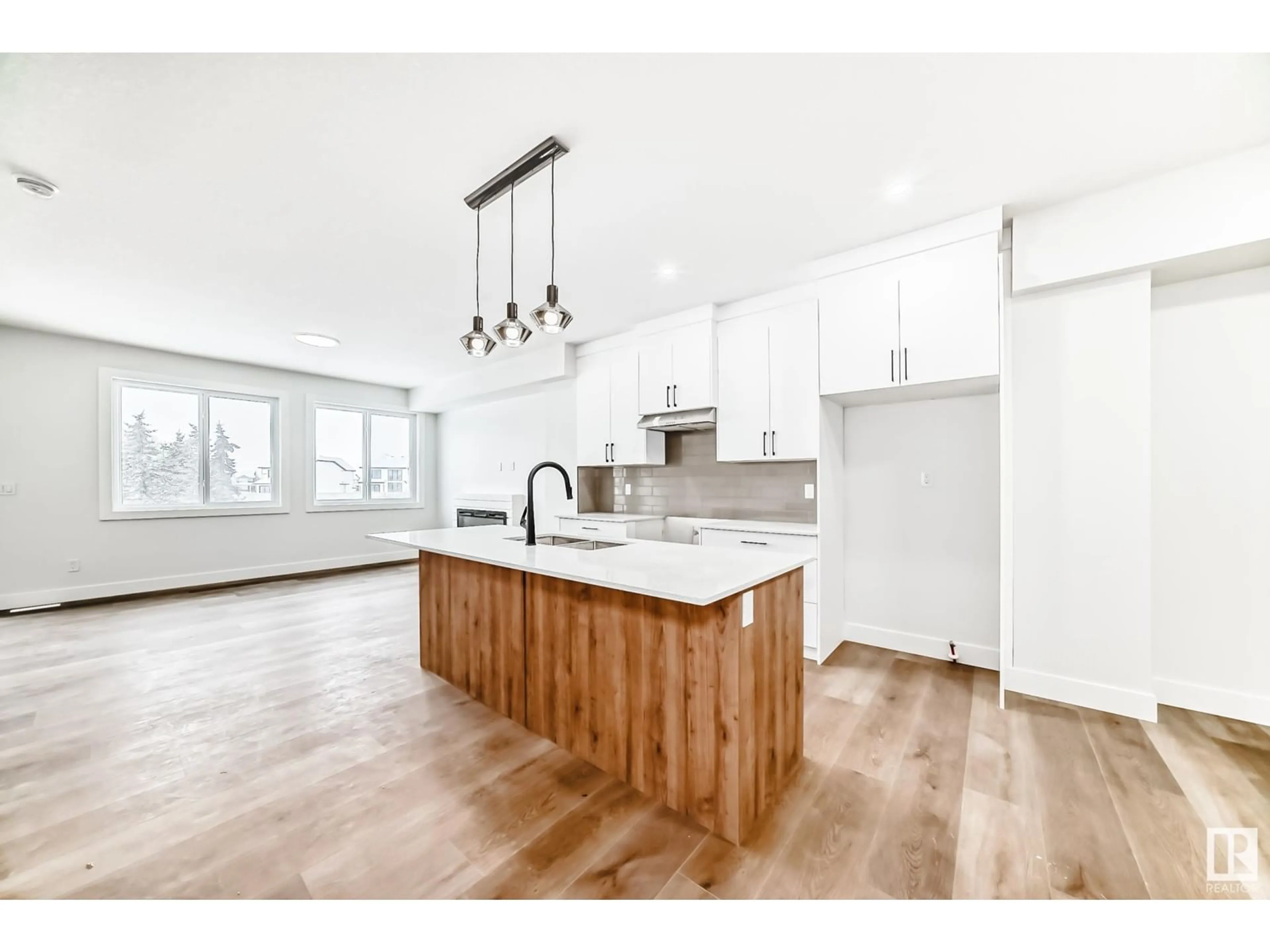 Open concept kitchen, wood/laminate floor for 5028 67 ST, Beaumont Alberta T4X2A2