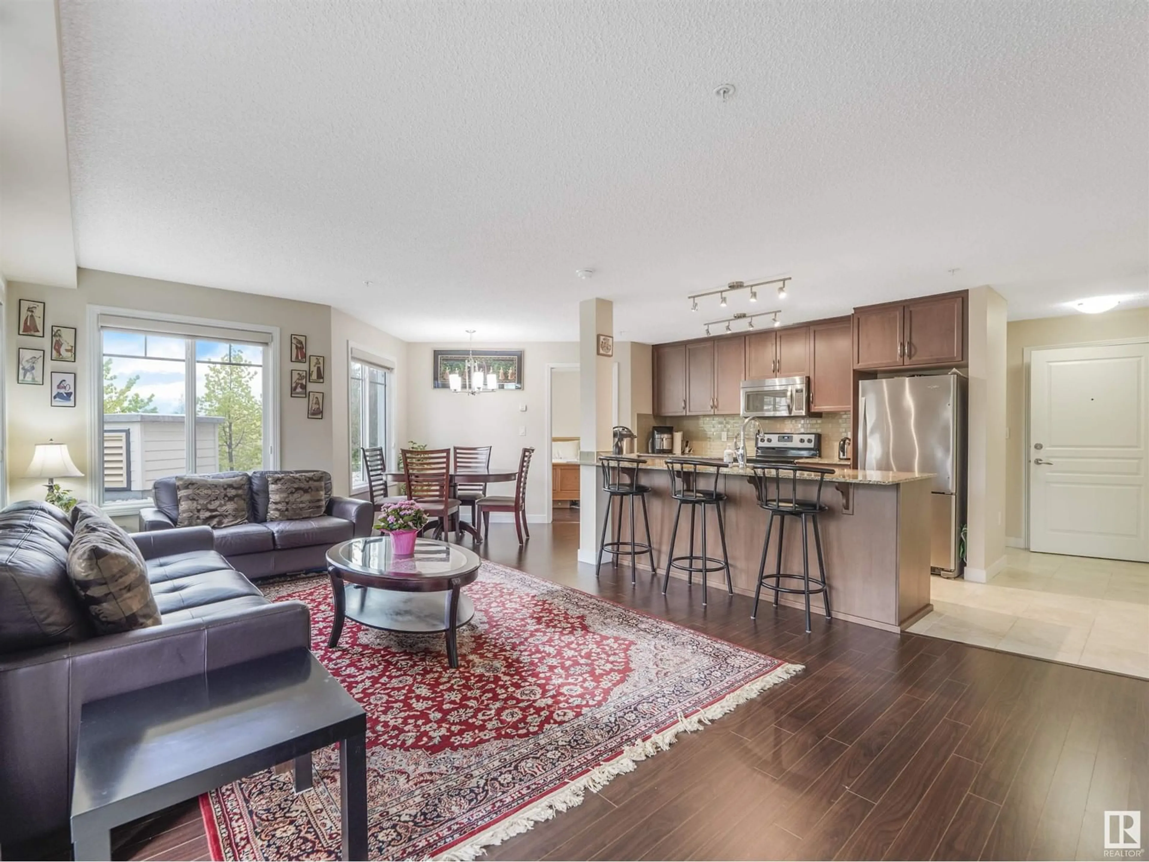 Open concept kitchen, wood/laminate floor for #110 7021 TERWILLIGAR ST NW NW, Edmonton Alberta T6R0W5