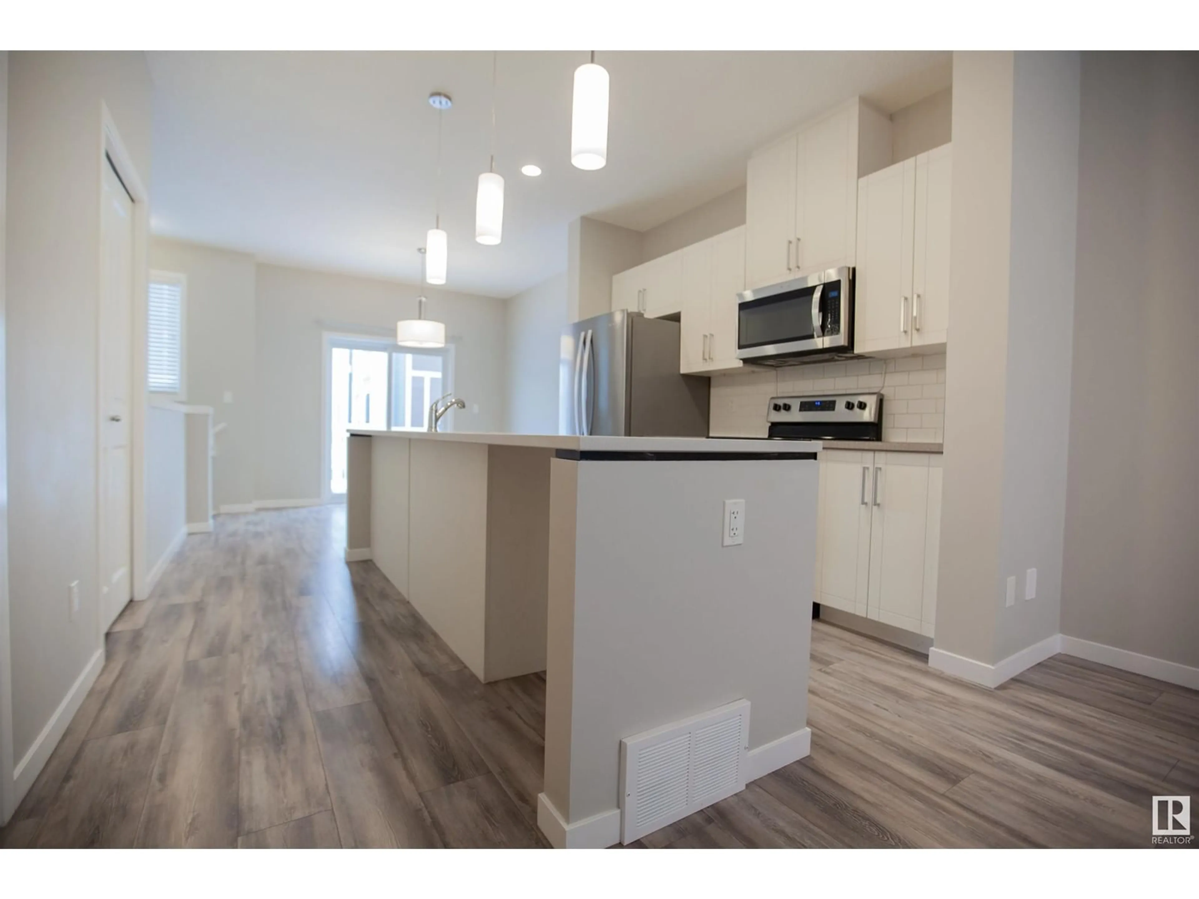 Open concept kitchen, wood/laminate floor for #95 320 SECORD BV NW, Edmonton Alberta T5T7E8