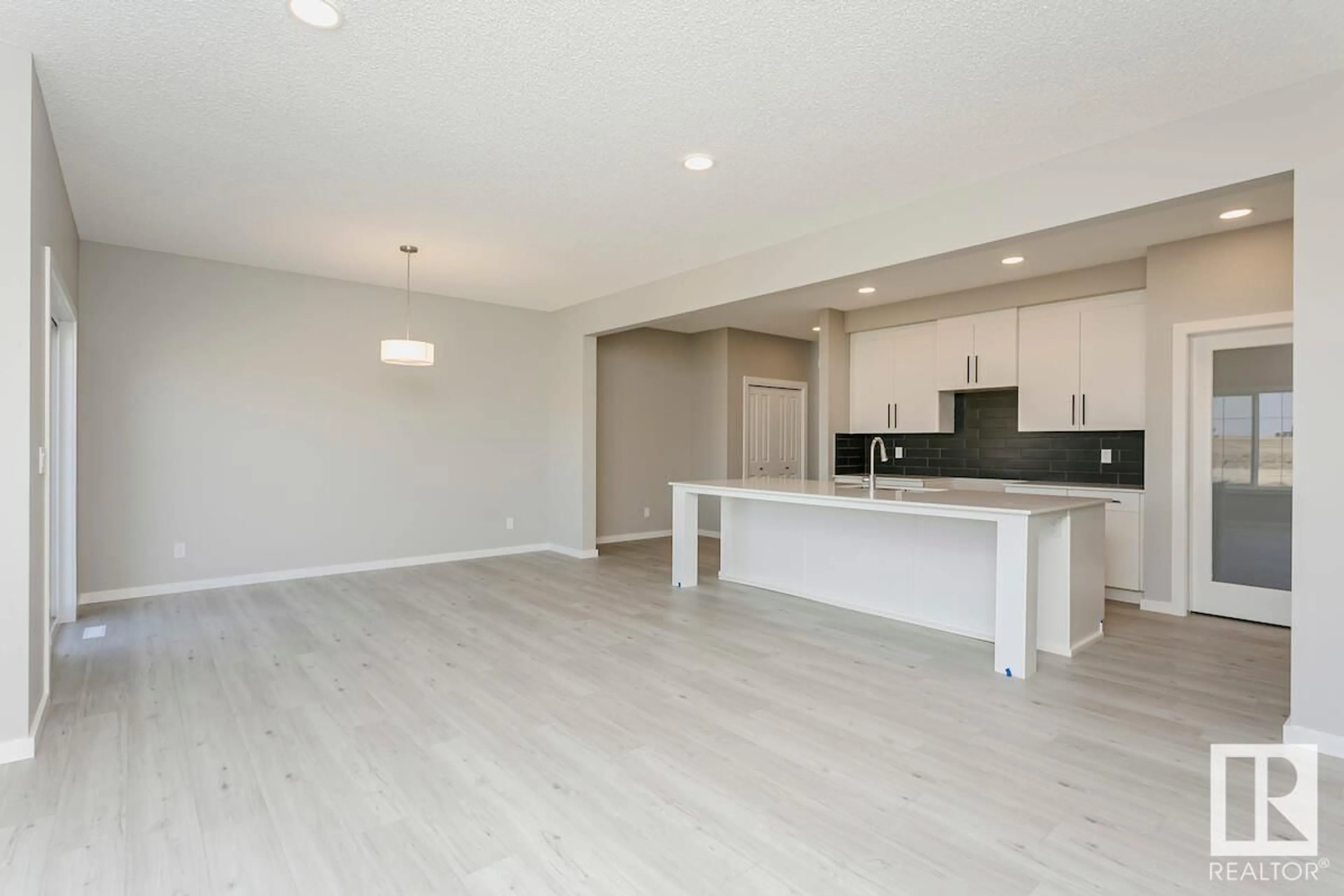 Open concept kitchen, wood/laminate floor for 17439 2 ST, Edmonton Alberta T5Y4G6