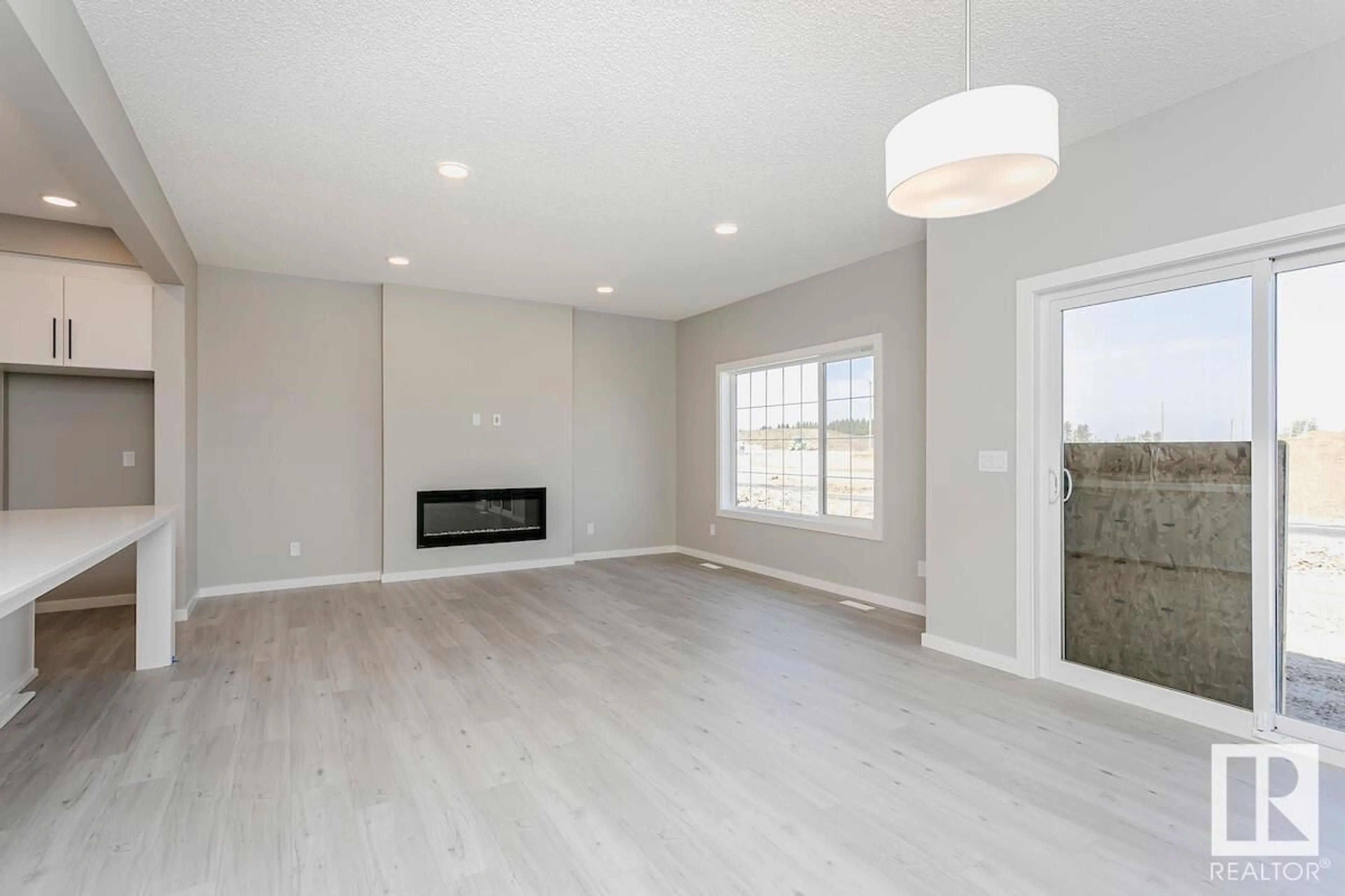 Living room with furniture, wood/laminate floor for 17439 2 ST NW, Edmonton Alberta T5Y4G6