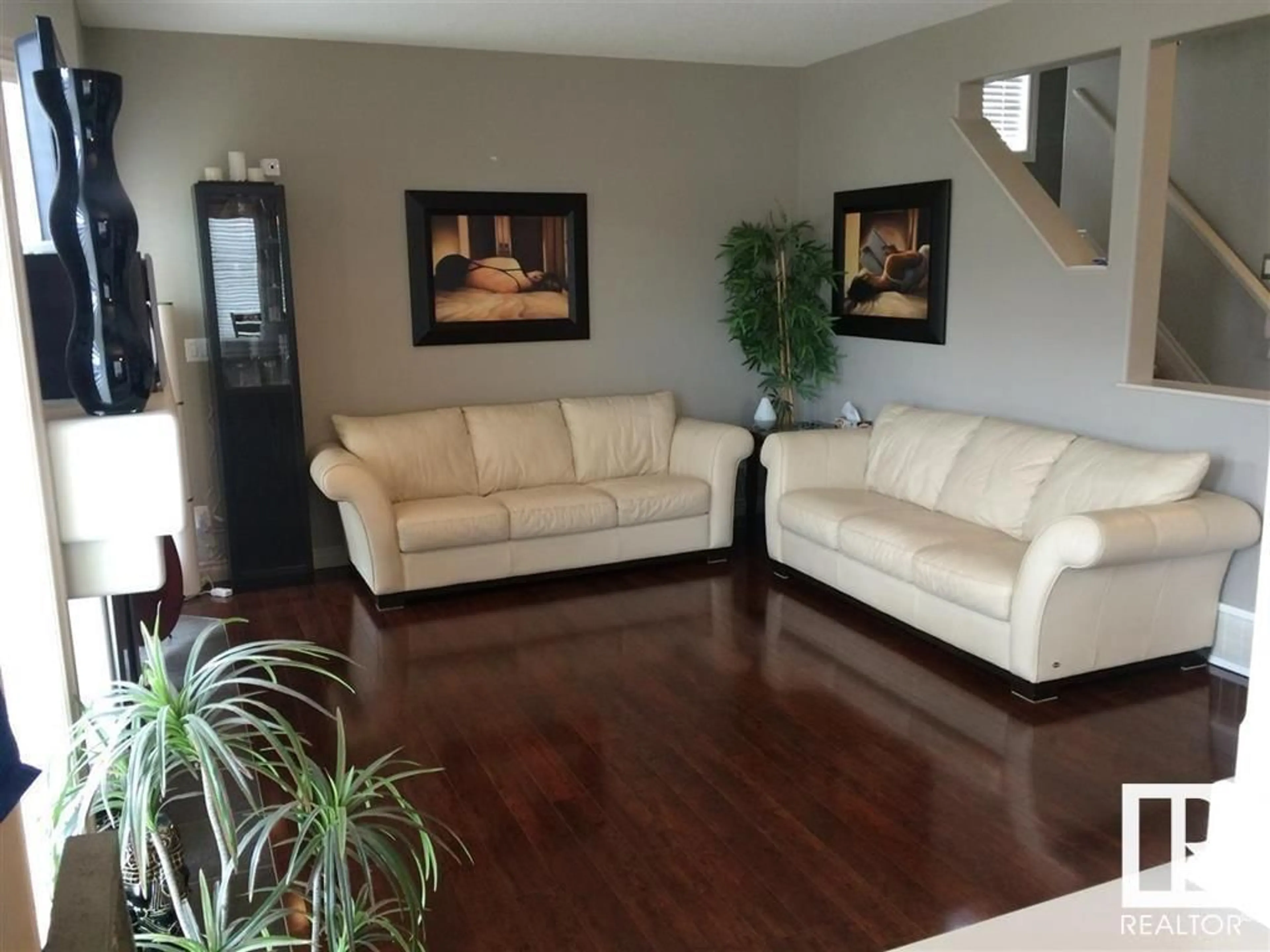 Living room with furniture, wood/laminate floor for 16403 37 ST NW, Edmonton Alberta T5Y0H9