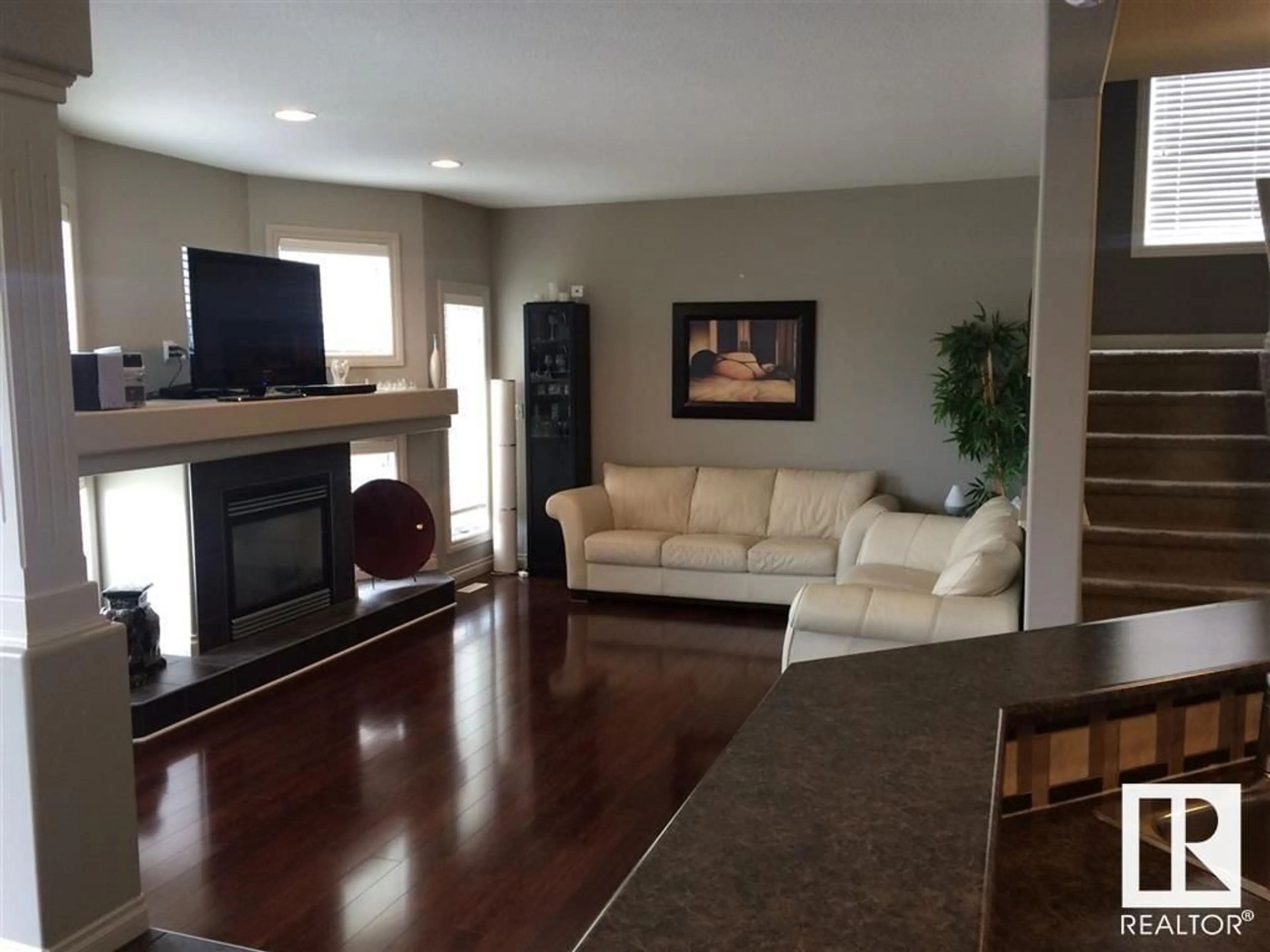 Living room with furniture, wood/laminate floor for 16403 37 ST NW, Edmonton Alberta T5Y0H9