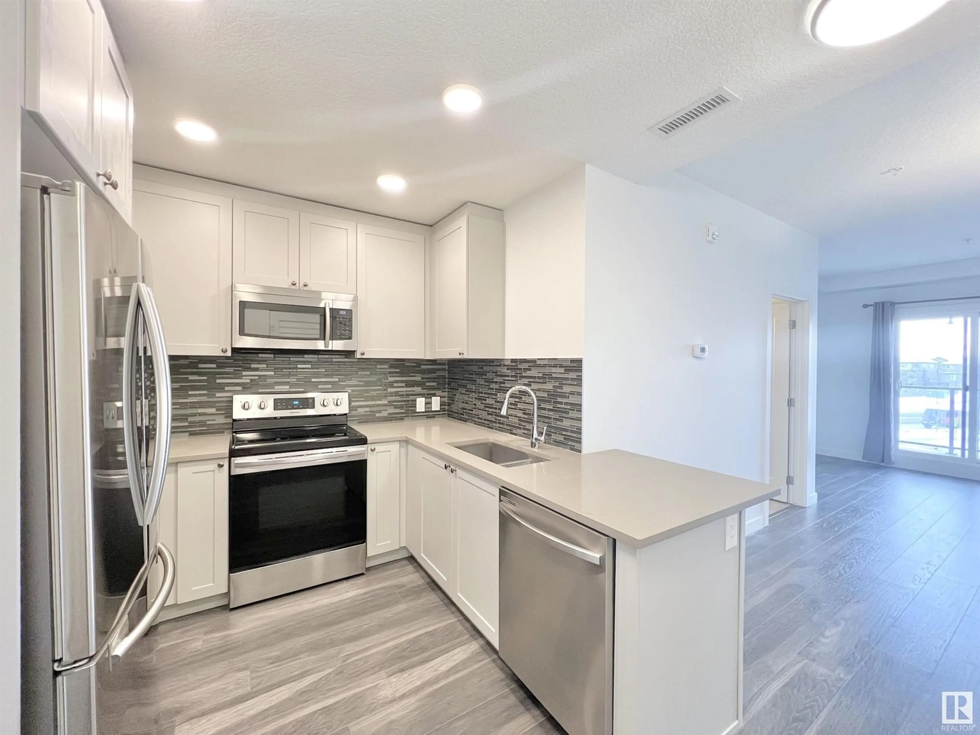 Open concept kitchen, ceramic/tile floor for #213 1316 WINDERMERE WY SW, Edmonton Alberta T6W2J3