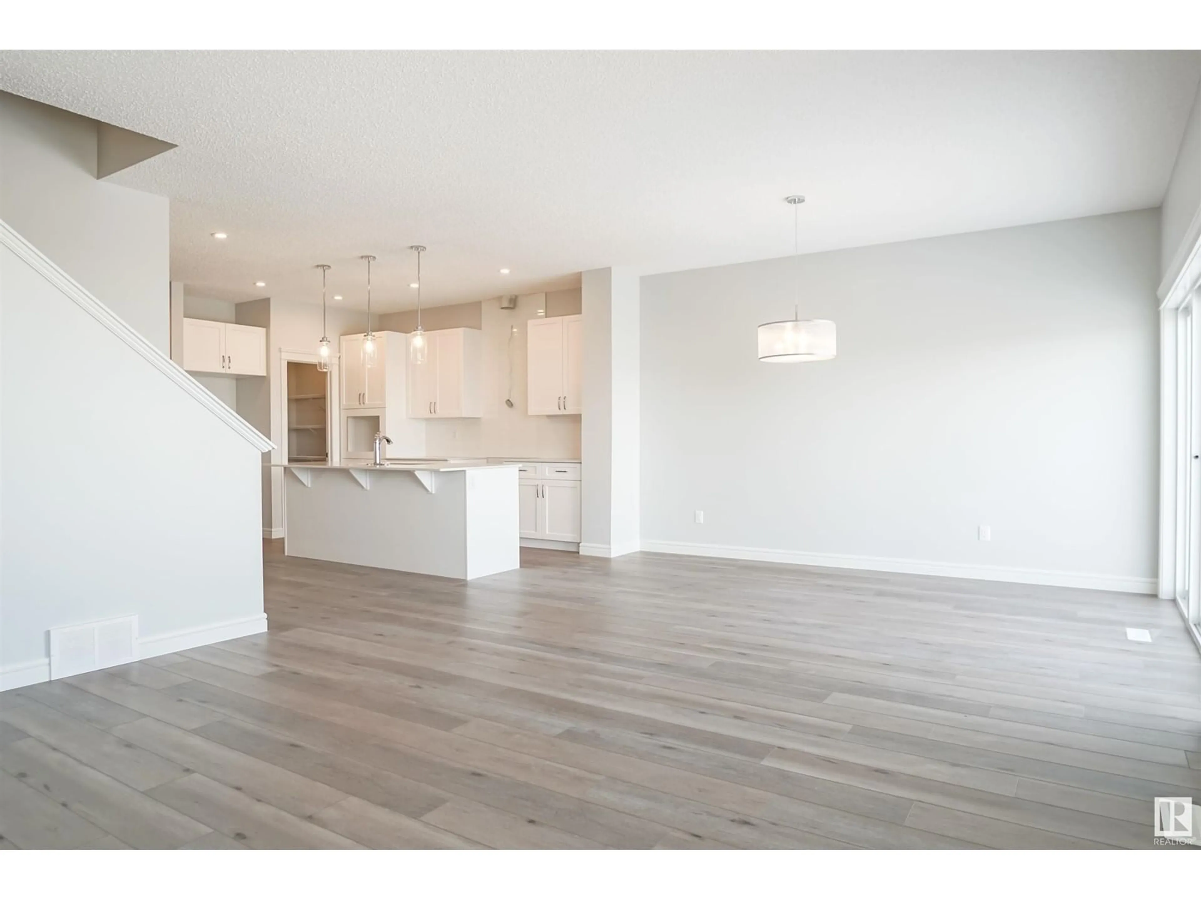 Open concept kitchen, wood/laminate floor for 16531 3 ST NE, Edmonton Alberta T5Y4E9