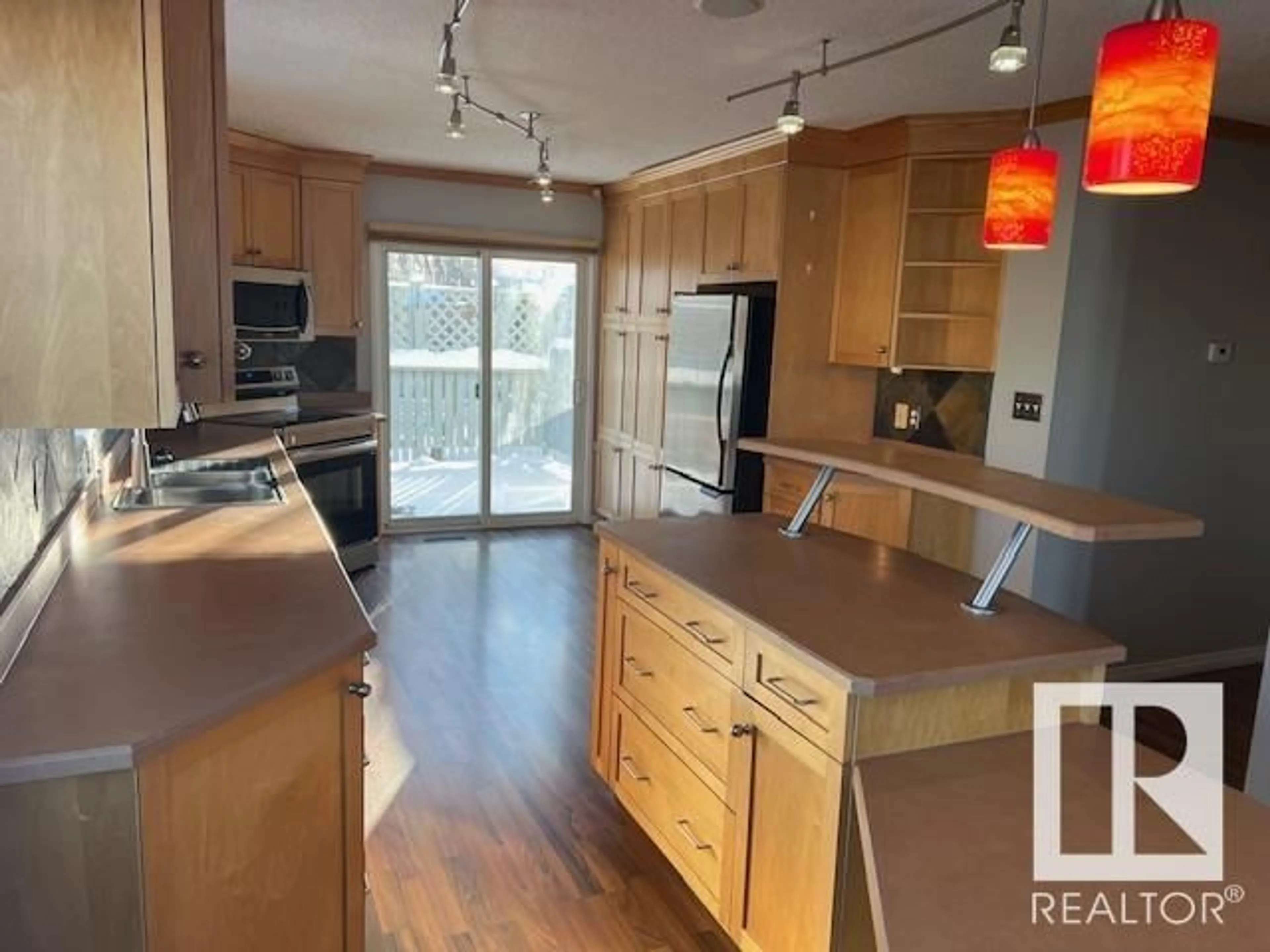 Open concept kitchen, wood/laminate floor for 19019 56 AV NW, Edmonton Alberta T6M2L3