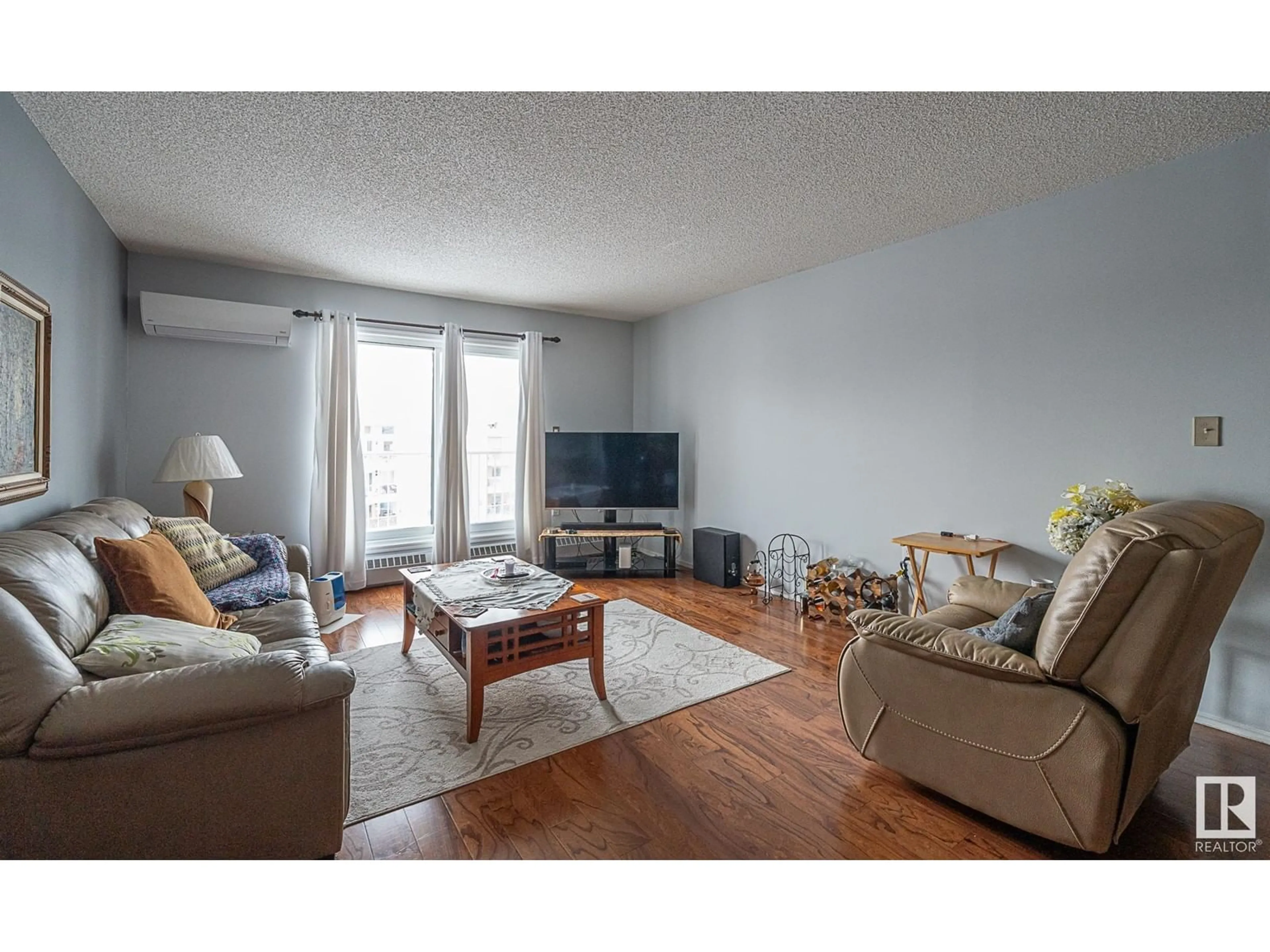 Living room with furniture, wood/laminate floor for #420 15499 CASTLE DOWNS RD NW, Edmonton Alberta T5X5Y3