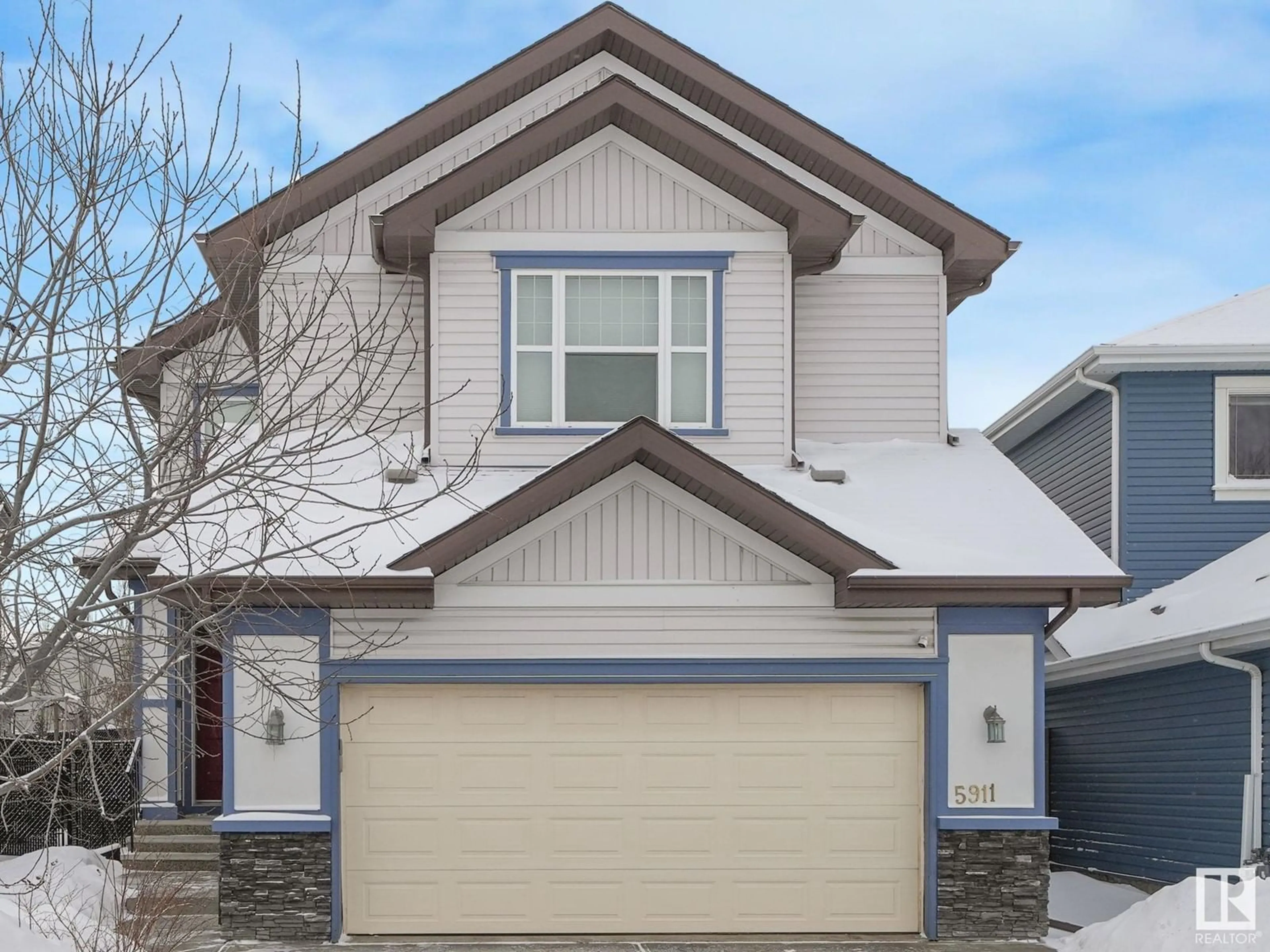 Home with vinyl exterior material, street for 5911 168 AV NW, Edmonton Alberta T5Y0P4