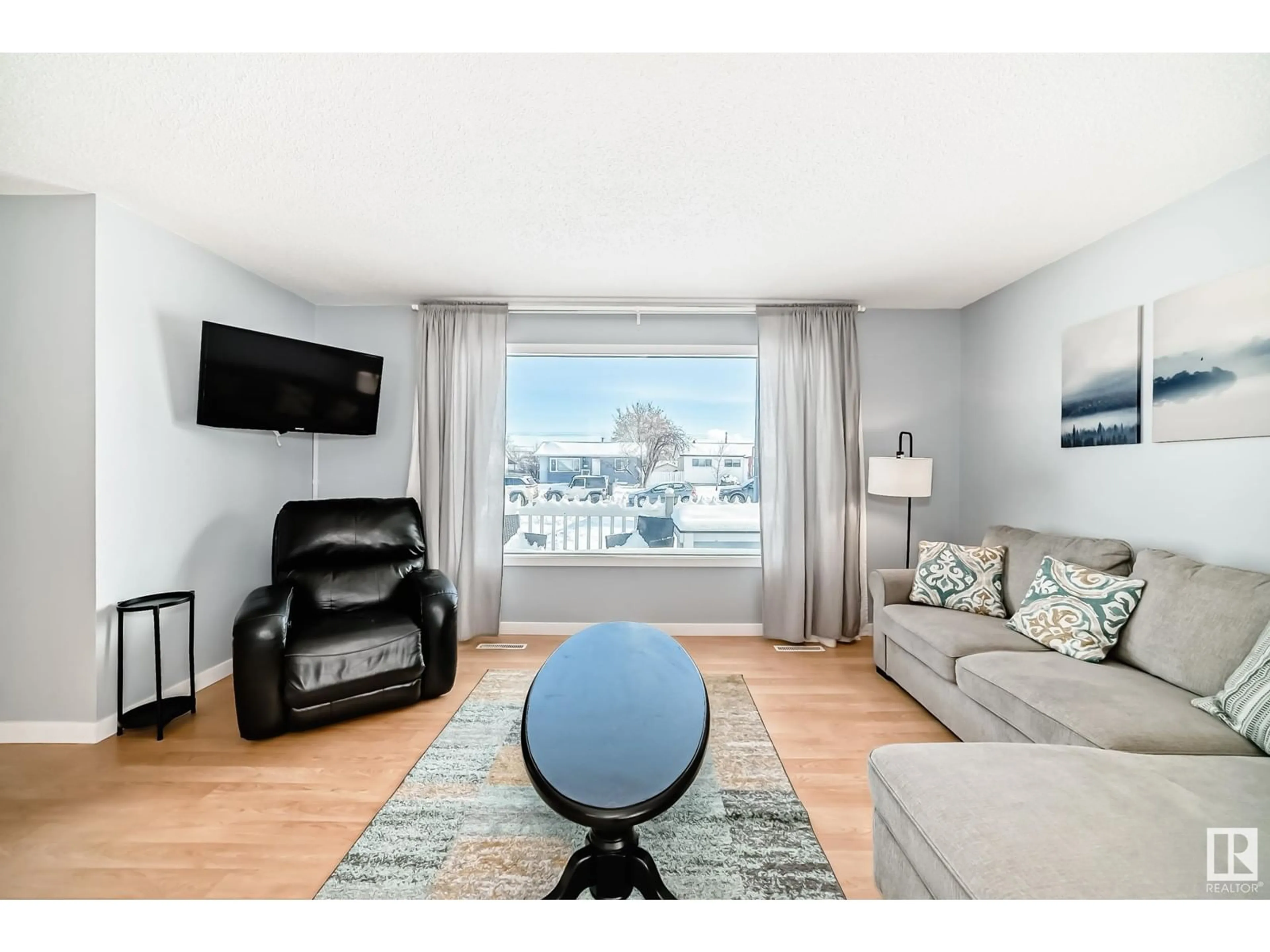 Living room with furniture, wood/laminate floor for 13228 68 ST NW, Edmonton Alberta T5C0G3