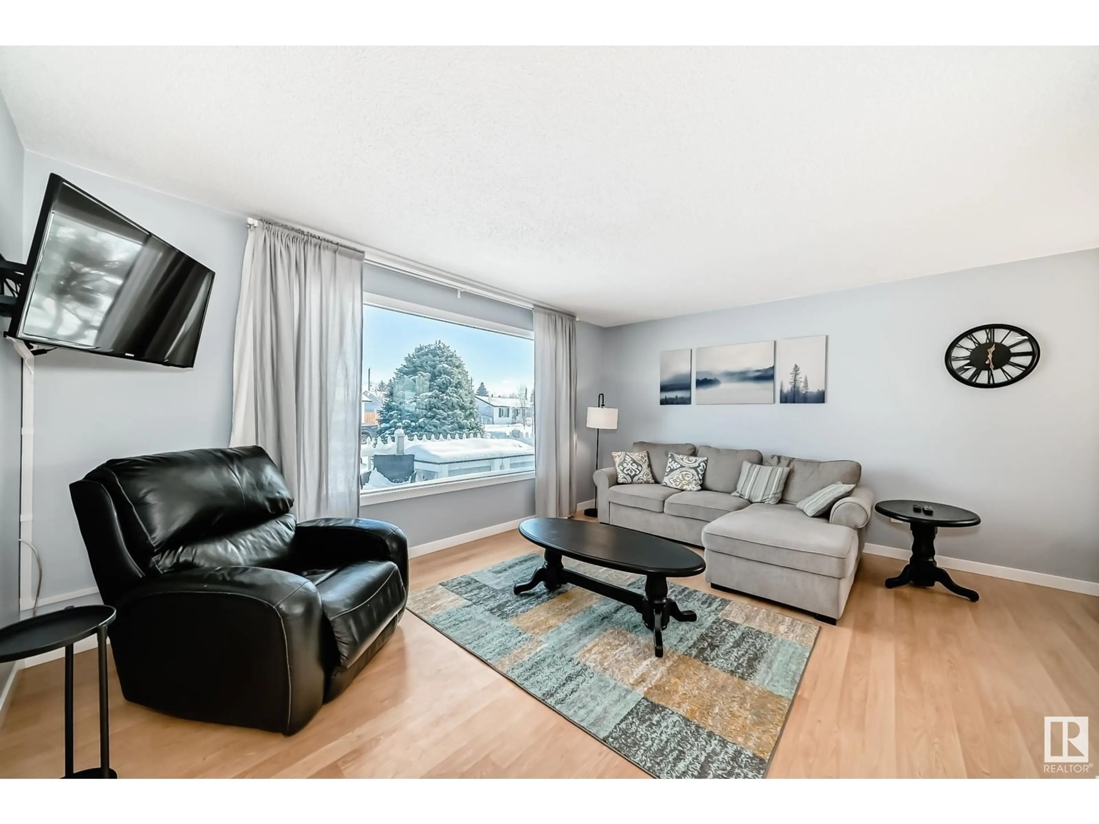 Living room with furniture, wood/laminate floor for 13228 68 ST NW, Edmonton Alberta T5C0G3