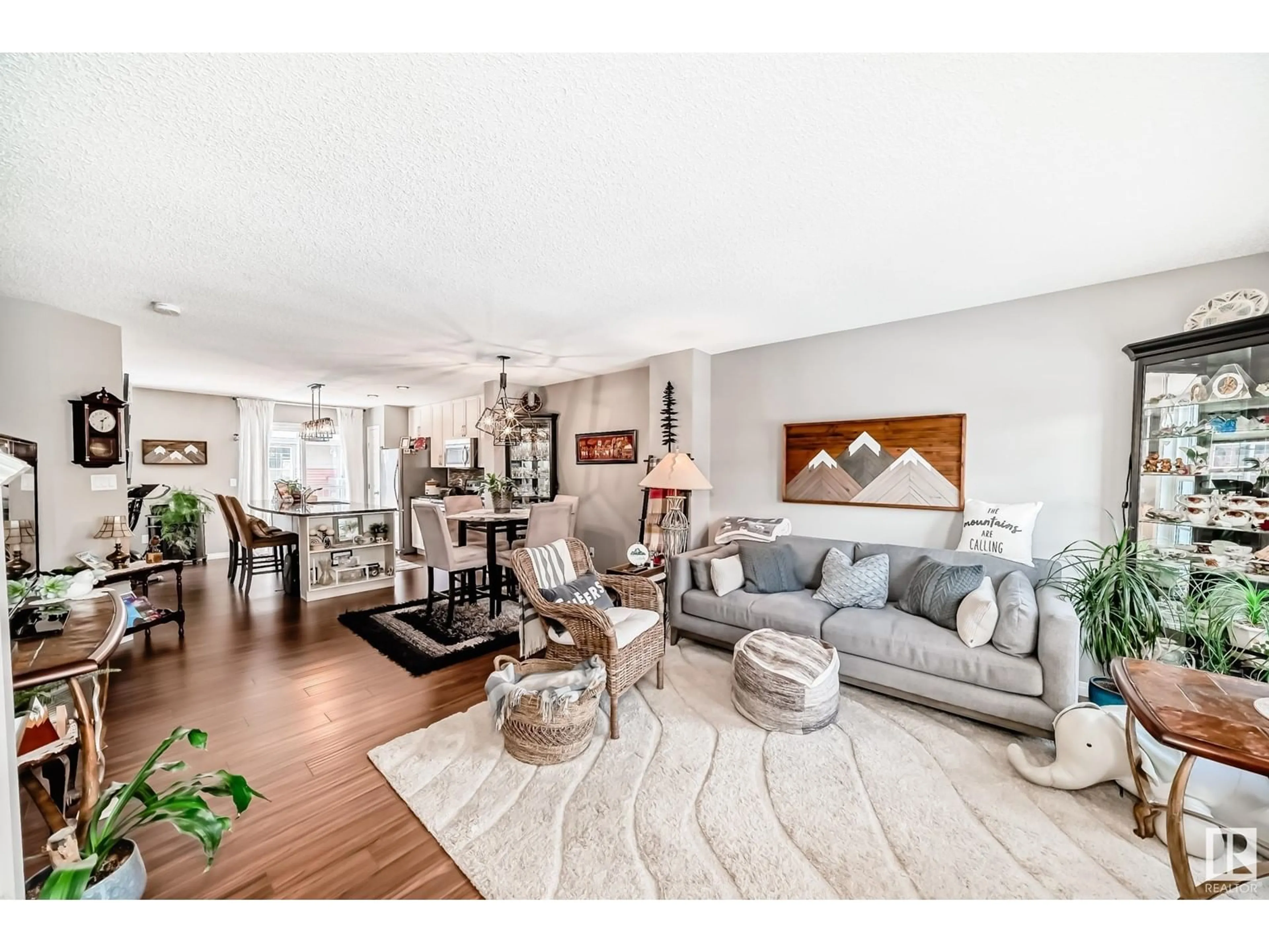 Living room with furniture, wood/laminate floor for #38 4029 ORCHARDS DR SW, Edmonton Alberta T6X1V2