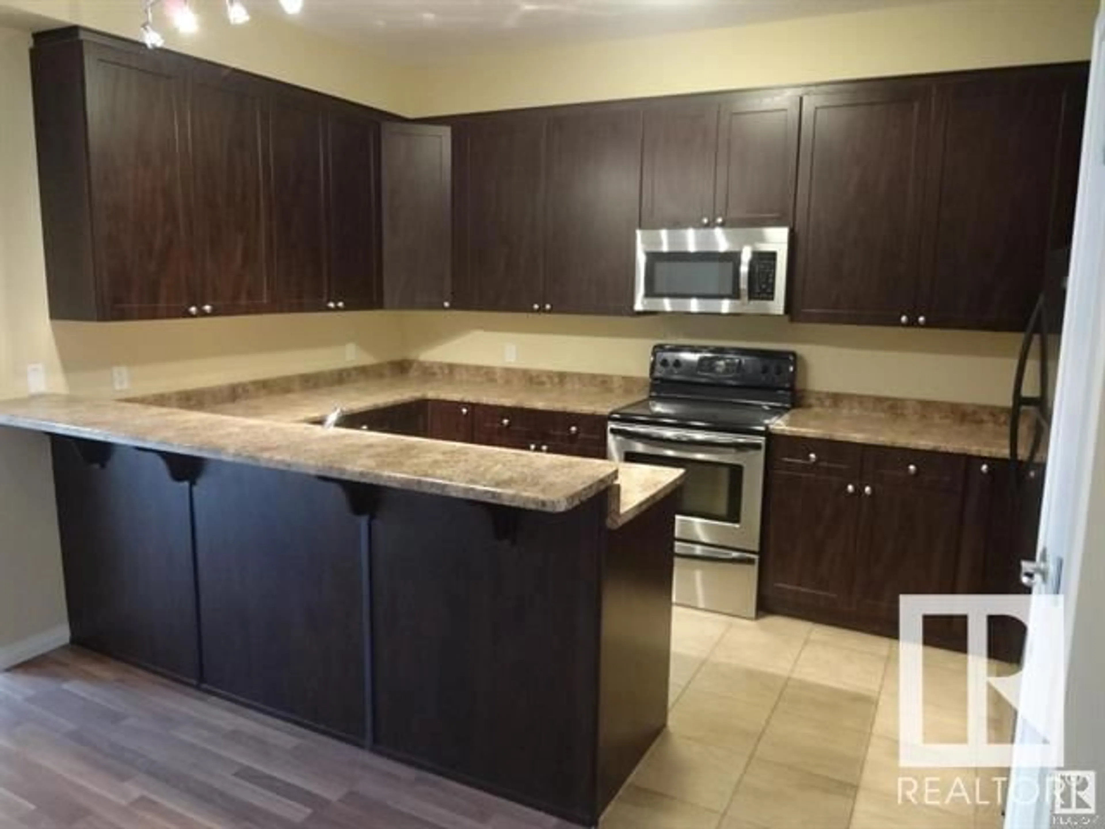 Open concept kitchen, ceramic/tile floor for #214 4316 139 AV NW, Edmonton Alberta T5Y0L1