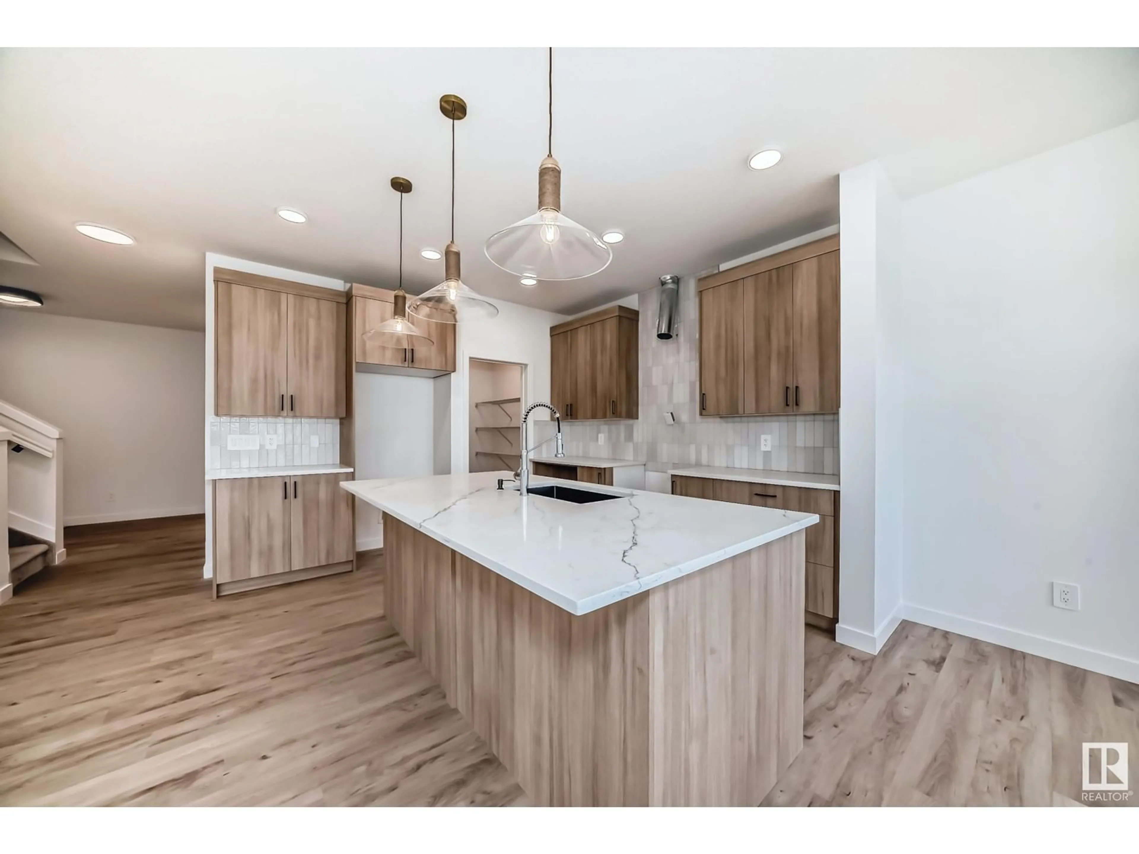 Open concept kitchen, wood/laminate floor for 2608 65 ST SW, Edmonton Alberta T6X3G5