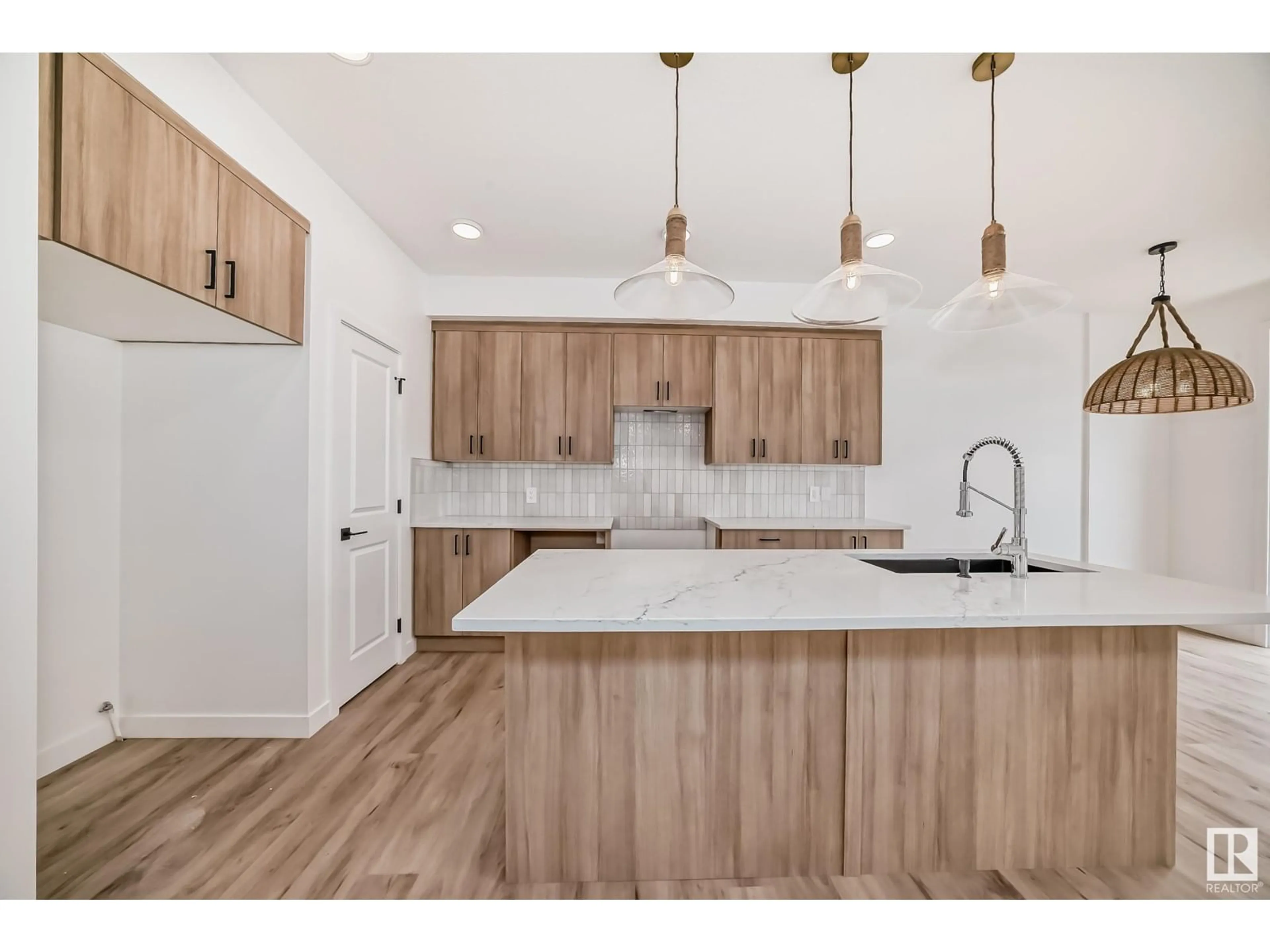 Open concept kitchen, wood/laminate floor for 8224 Kiriak LO SW, Edmonton Alberta T6W4R4