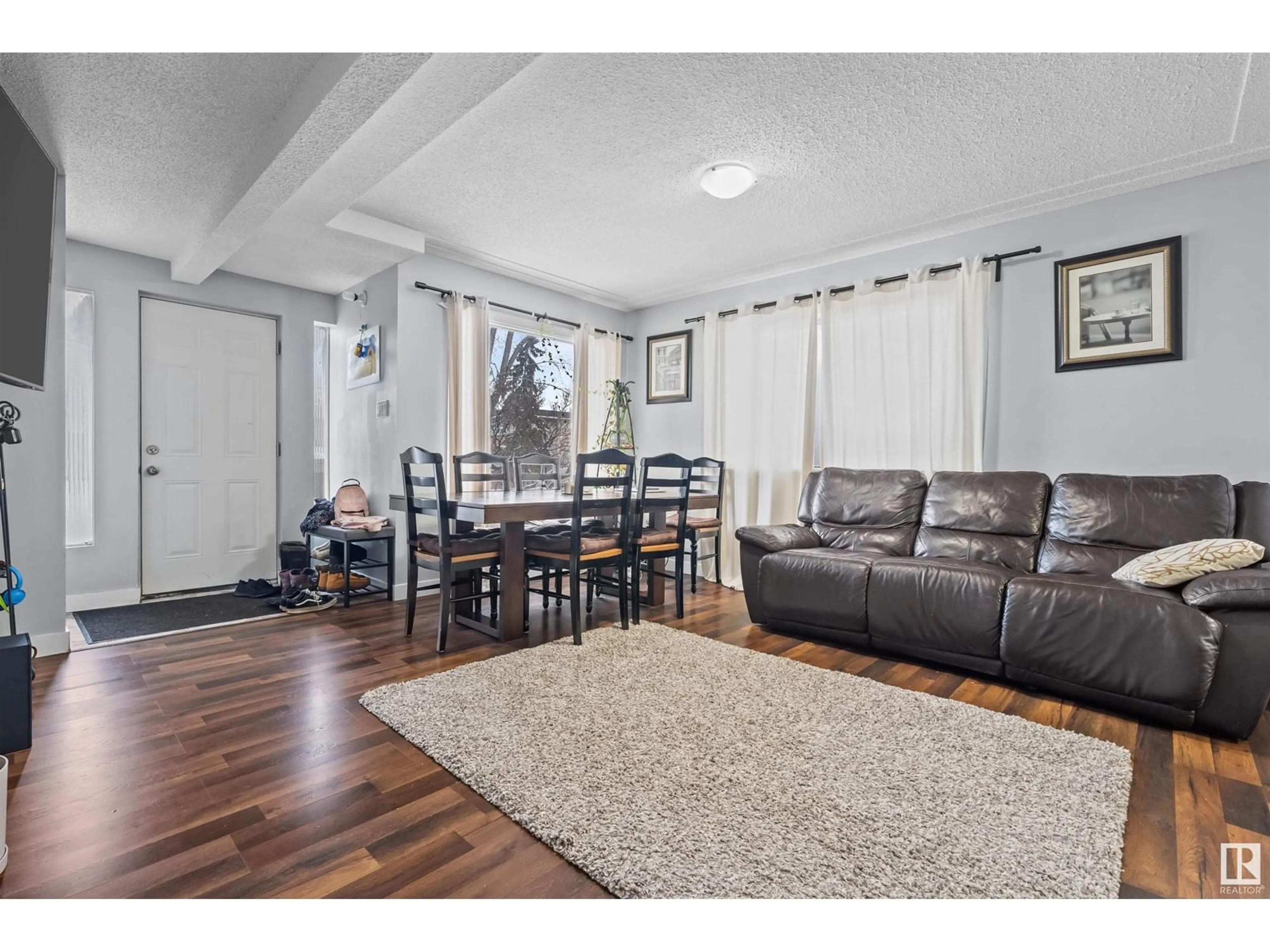 Living room with furniture, wood/laminate floor for 9821 76 AV NW, Edmonton Alberta T6E1K6