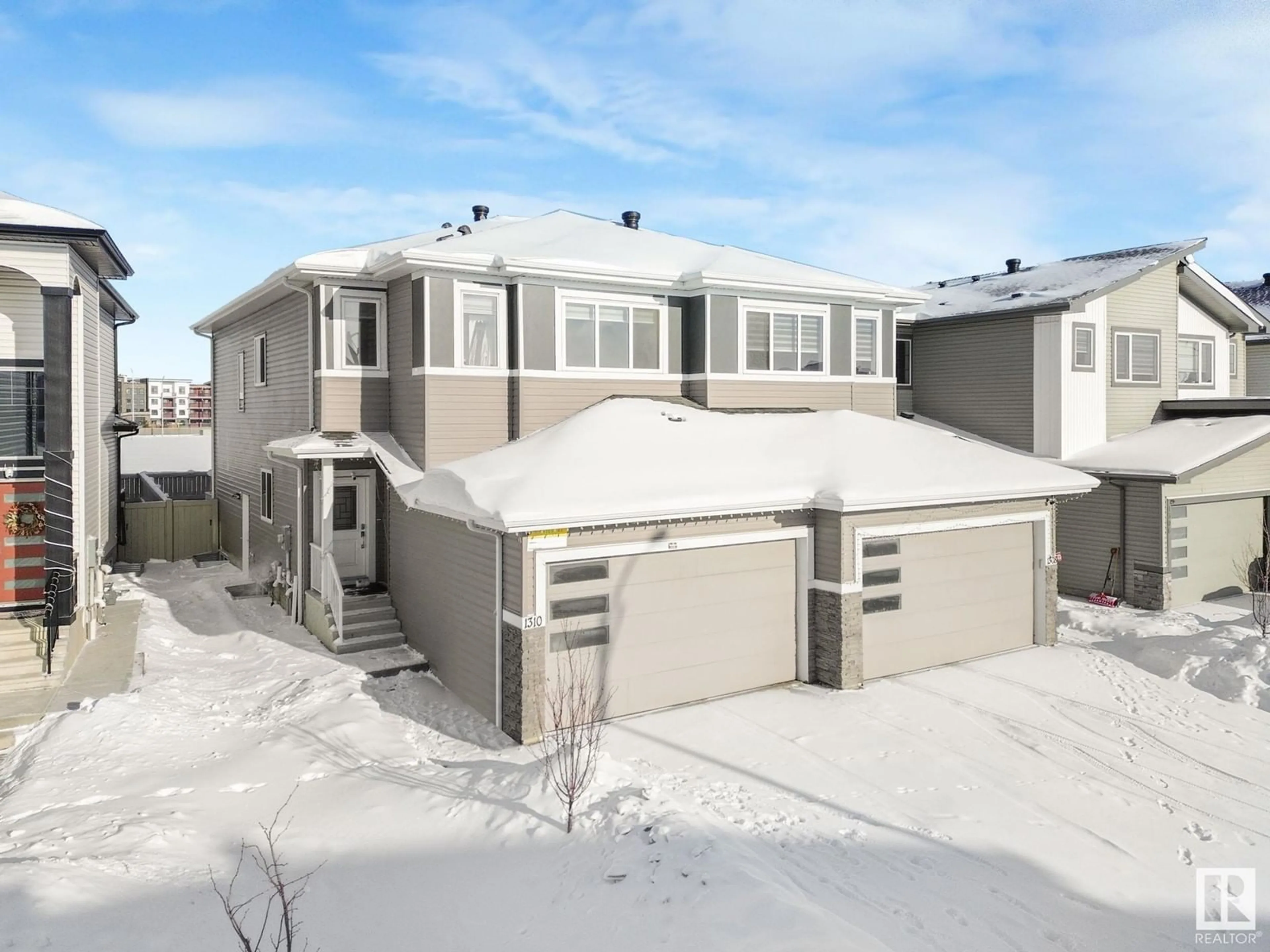 Home with vinyl exterior material, street for 1310 17 AV NW, Edmonton Alberta T6T2N5