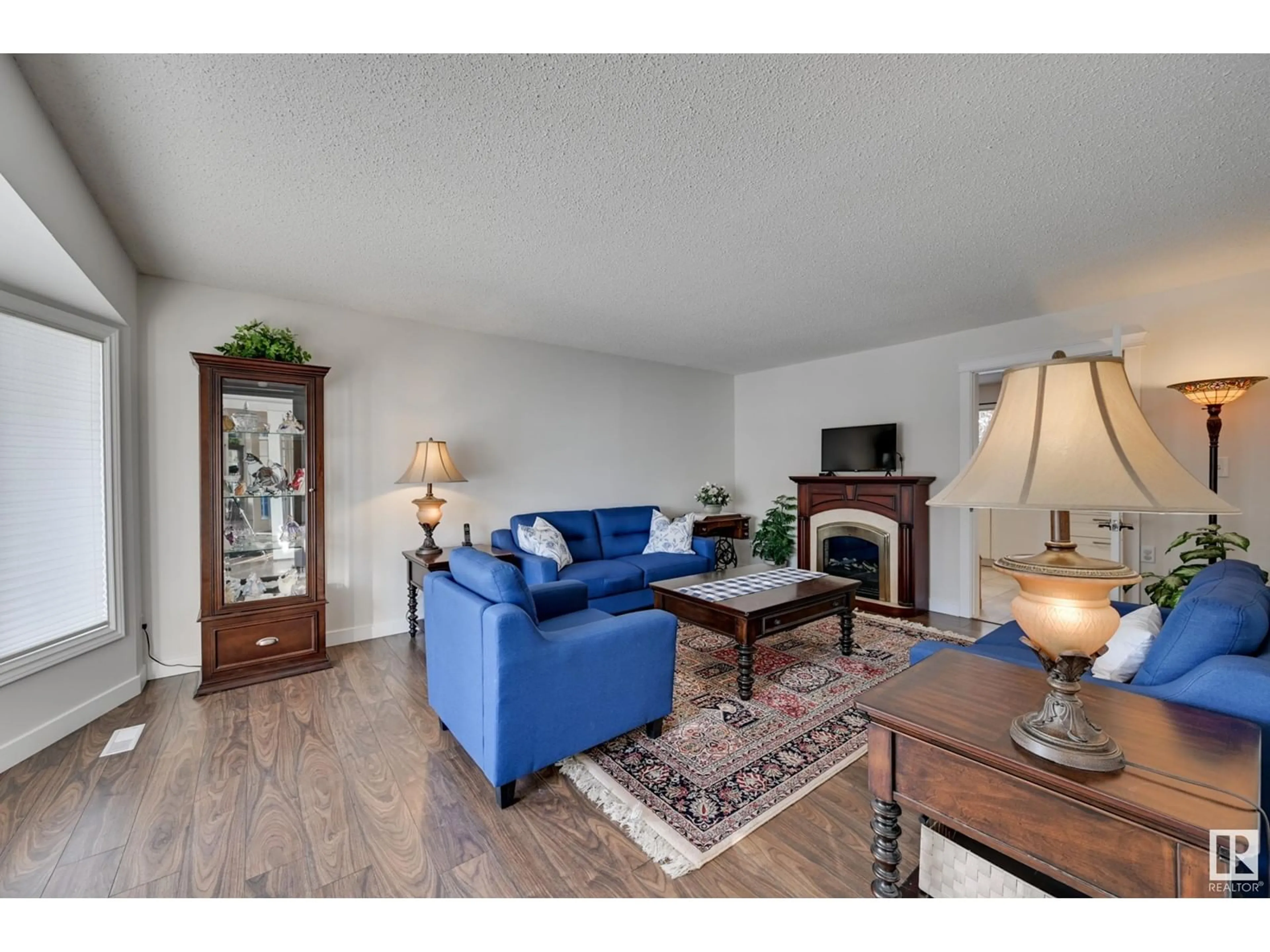 Living room with furniture, wood/laminate floor for 15442 105 ST NW, Edmonton Alberta T5X4G2