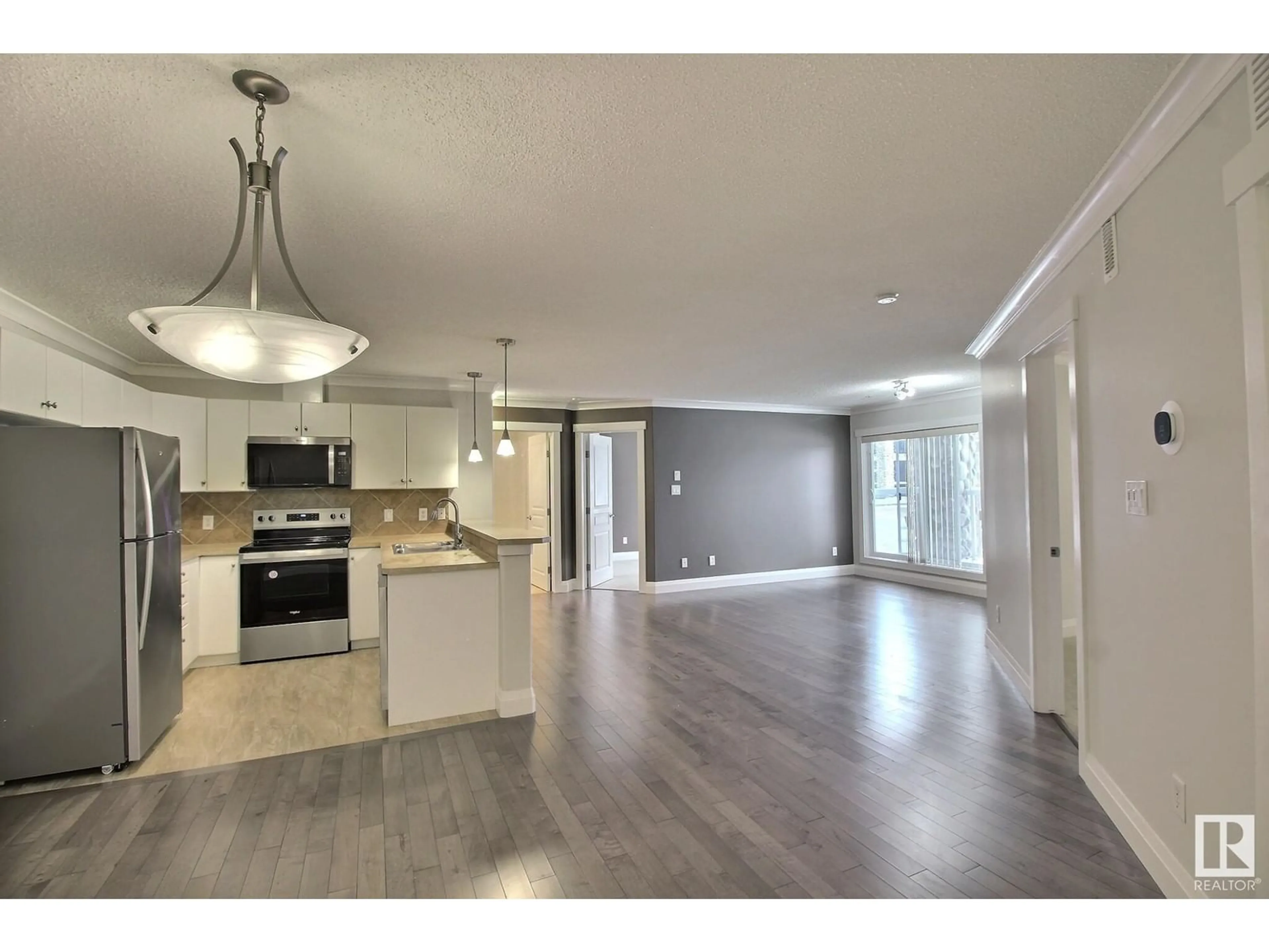 Open concept kitchen, wood/laminate floor for #108 16035 132 ST NW, Edmonton Alberta T6V0B4