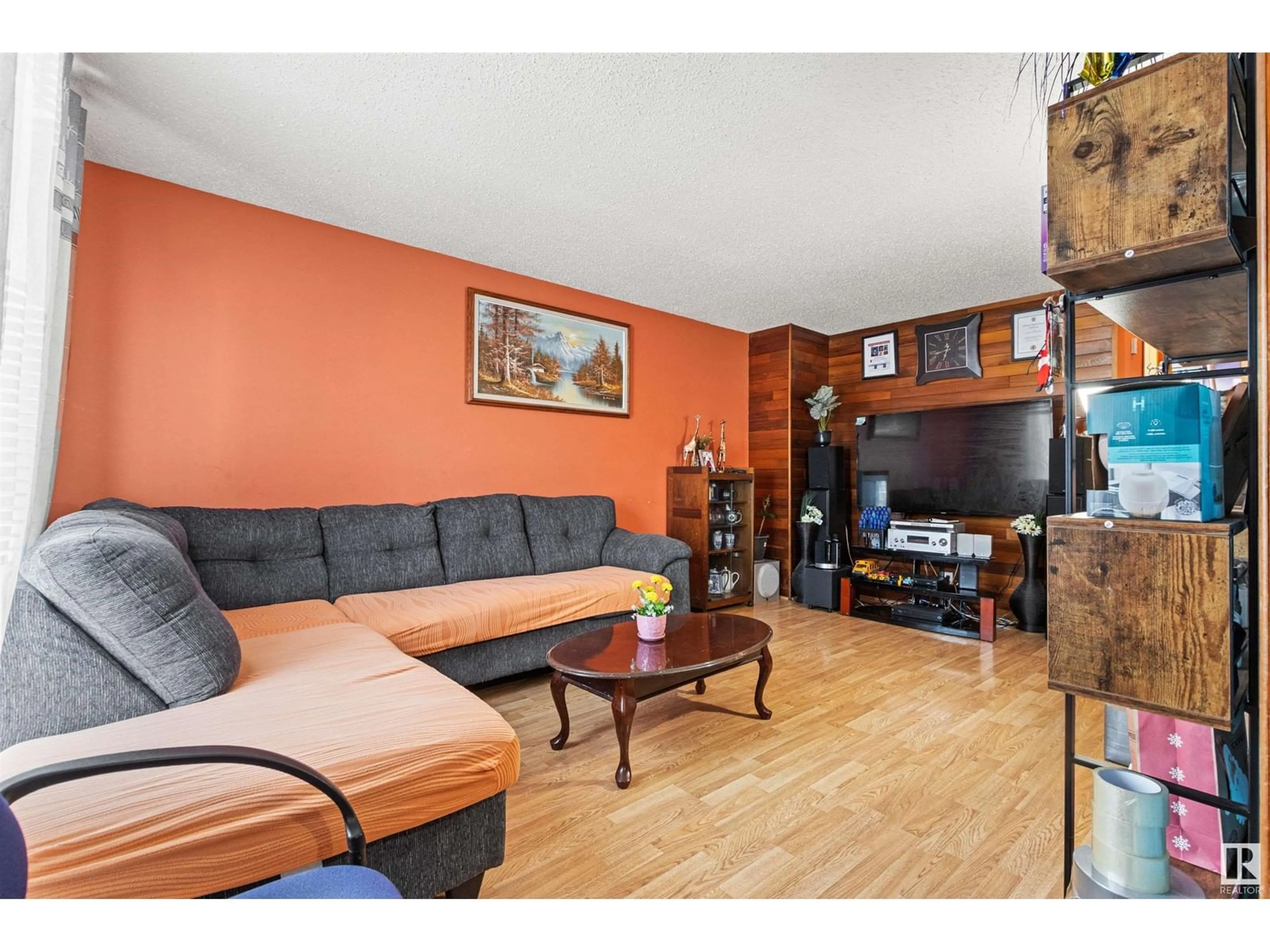 Living room with furniture, wood/laminate floor for 4519 32A AV NW, Edmonton Alberta T6L4K7